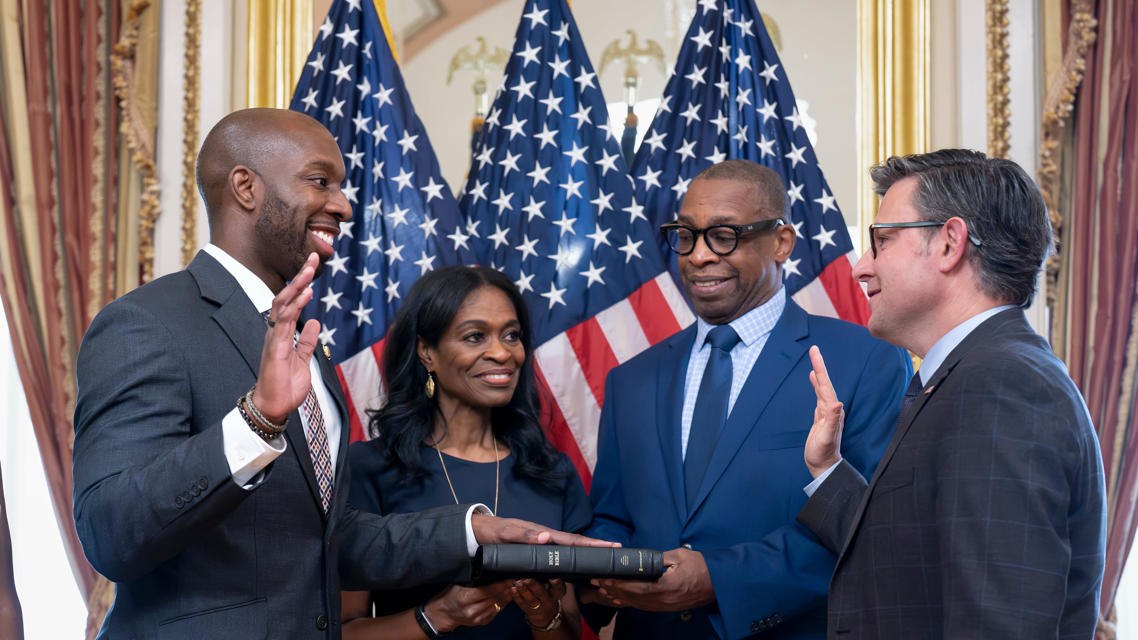 From left, new Rep. Everton Blair, D-Ga., joined by his mother Fiona Blair and father Everton Blair Sr., stands for a swearing-in ceremony with Speaker of the House Mike Johnson, R-La., after he won a special election to replace the late Georgia Rep. David Scott, at the Capitol in Washington, Tuesday, Sept. 1, 2026. (AP Photo/J. Scott Applewhite)