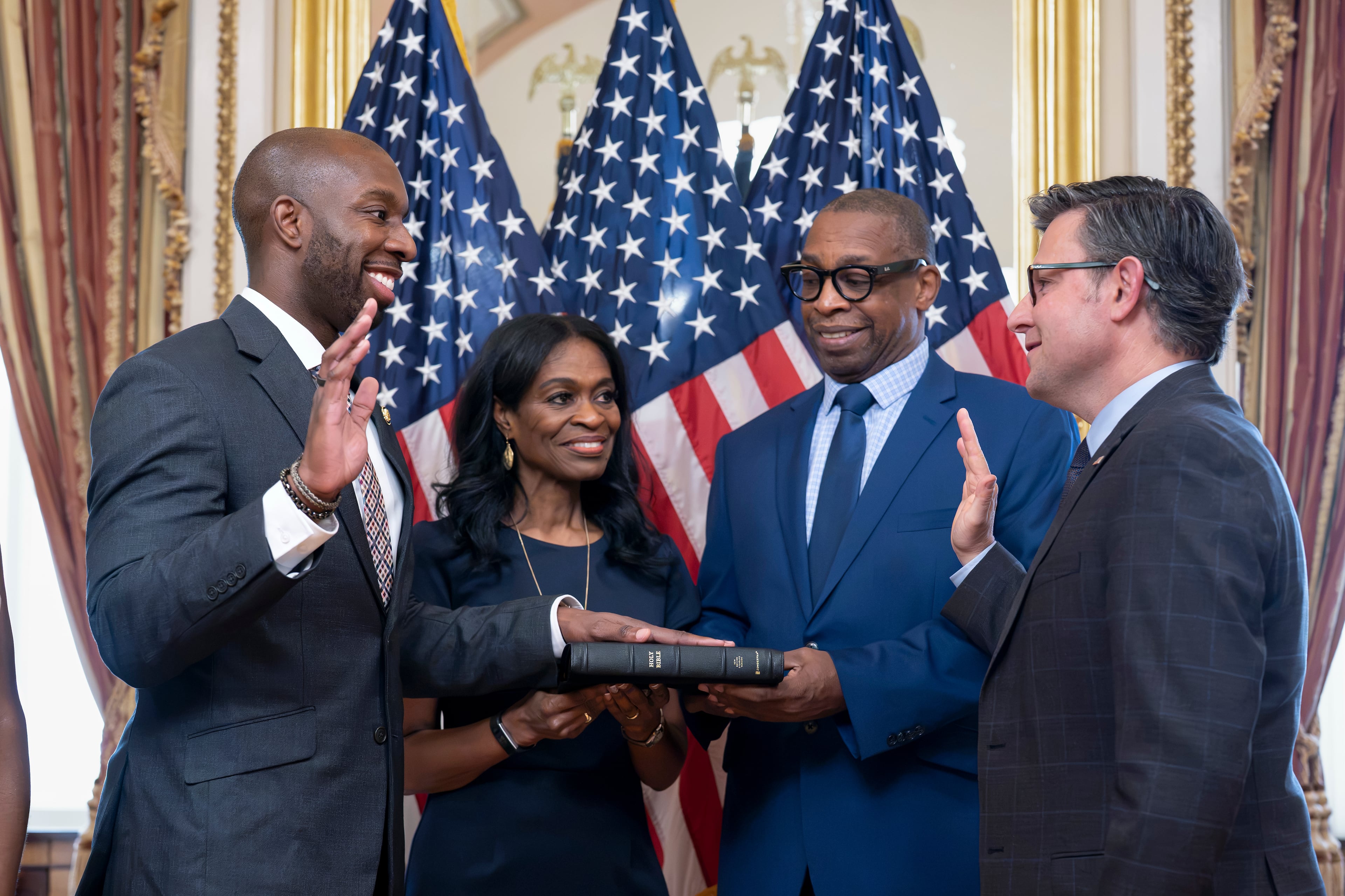 From left, new Rep. Everton Blair, D-Ga., joined by his mother Fiona Blair and father Everton Blair Sr., stands for a swearing-in ceremony with Speaker of the House Mike Johnson, R-La., after he won a special election to replace the late Georgia Rep. David Scott, at the Capitol in Washington, Tuesday, Sept. 1, 2026. (AP Photo/J. Scott Applewhite)