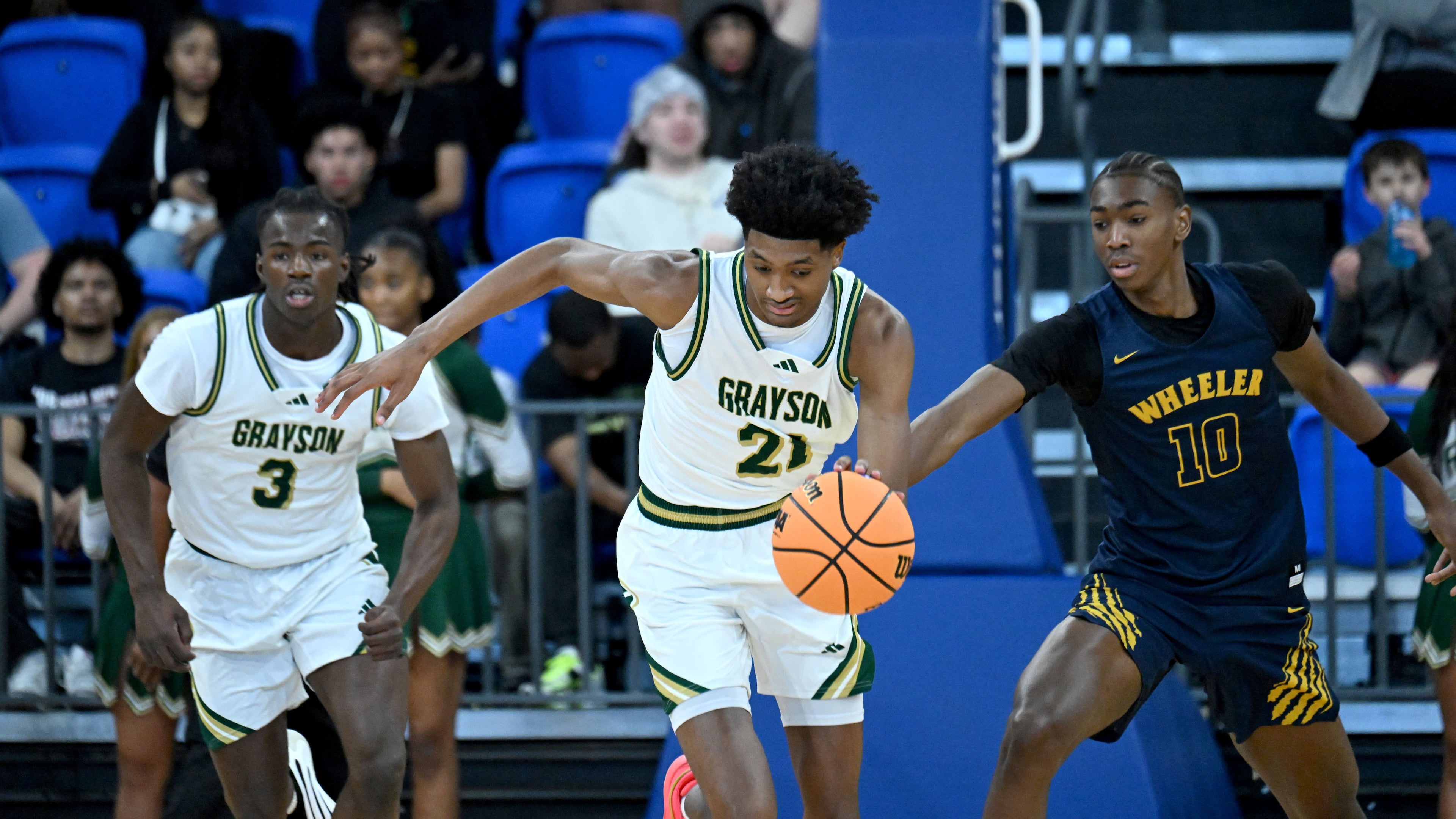 While at Grayson, Jake Wilkins brings the ball upcourt during the first half of the GHSA Class 6A Boys State Basketball playoffs. Wilkins will continue to wear No. 21, his dad Dominique's number, when playing for Georgia. (Hyosub Shin/AJC)