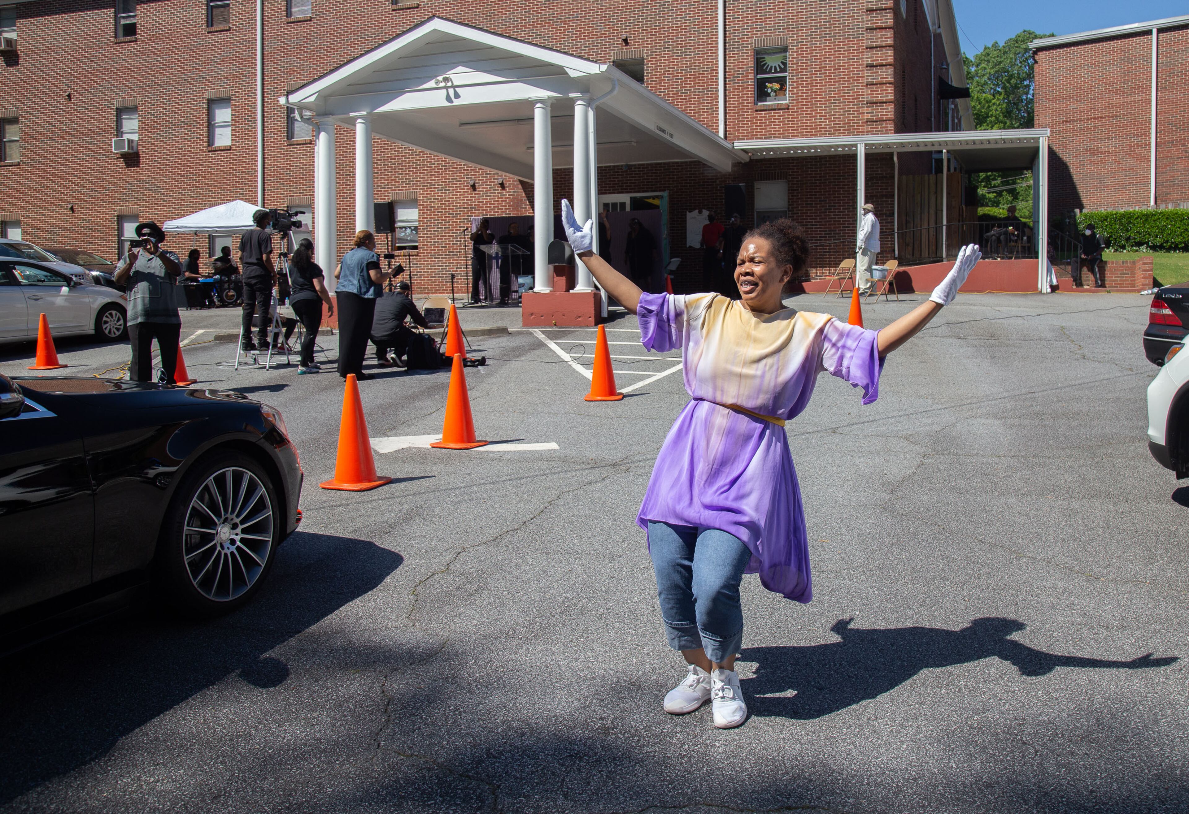 One of the church's New Beginning Dancers dances during the drive-in Sunday service at the New Beginning Full Gospel Baptist Church in Decatur May 3, 2020. STEVE SCHAEFER / SPECIAL TO THE AJC