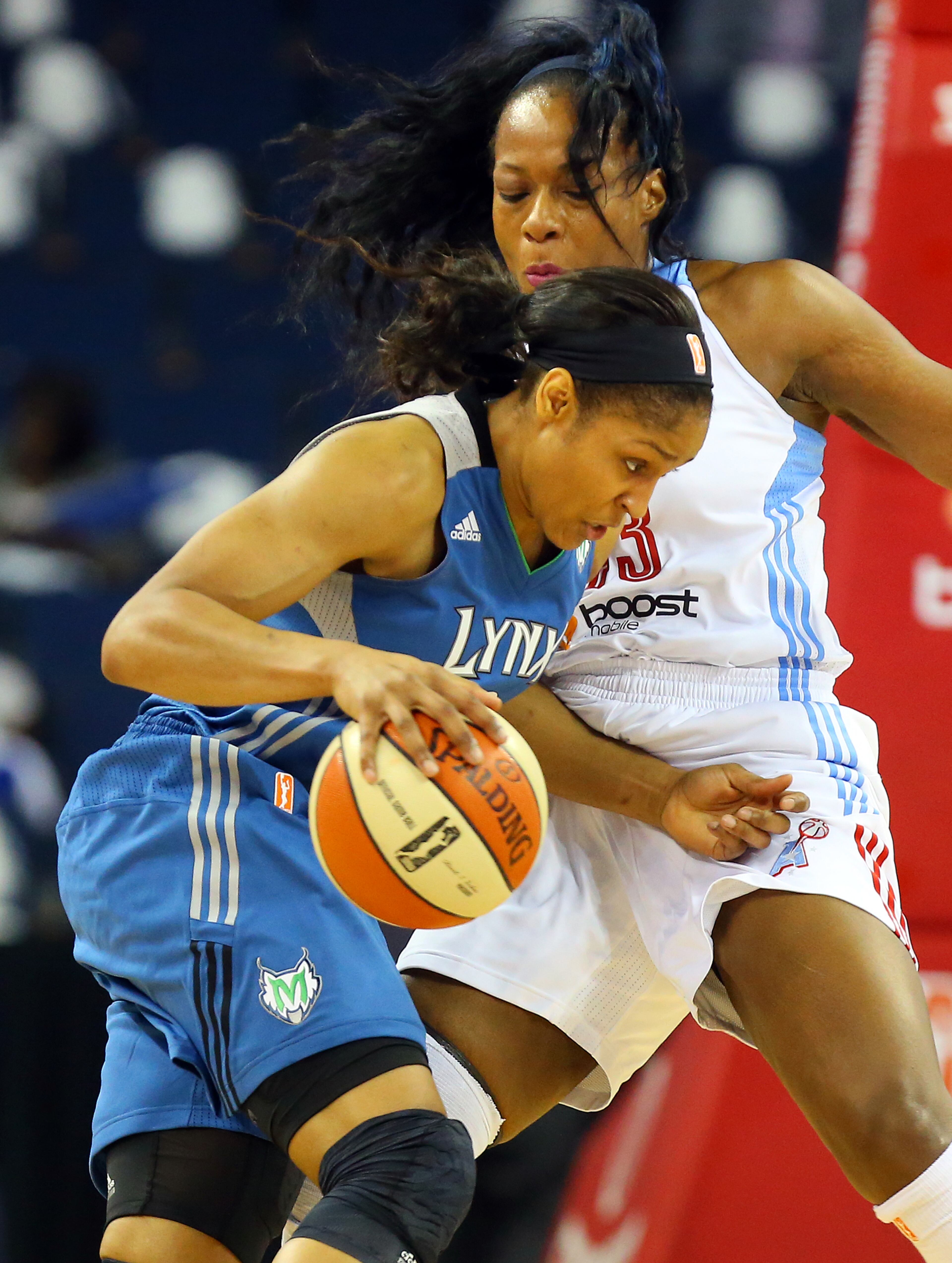 Lynx forward Myra Moore drives against Dream forward Le'coe Willingham during the first half of their WNBA Finals basketball game 3 on Thursday, Oct. 10, 2013, in Duluth.