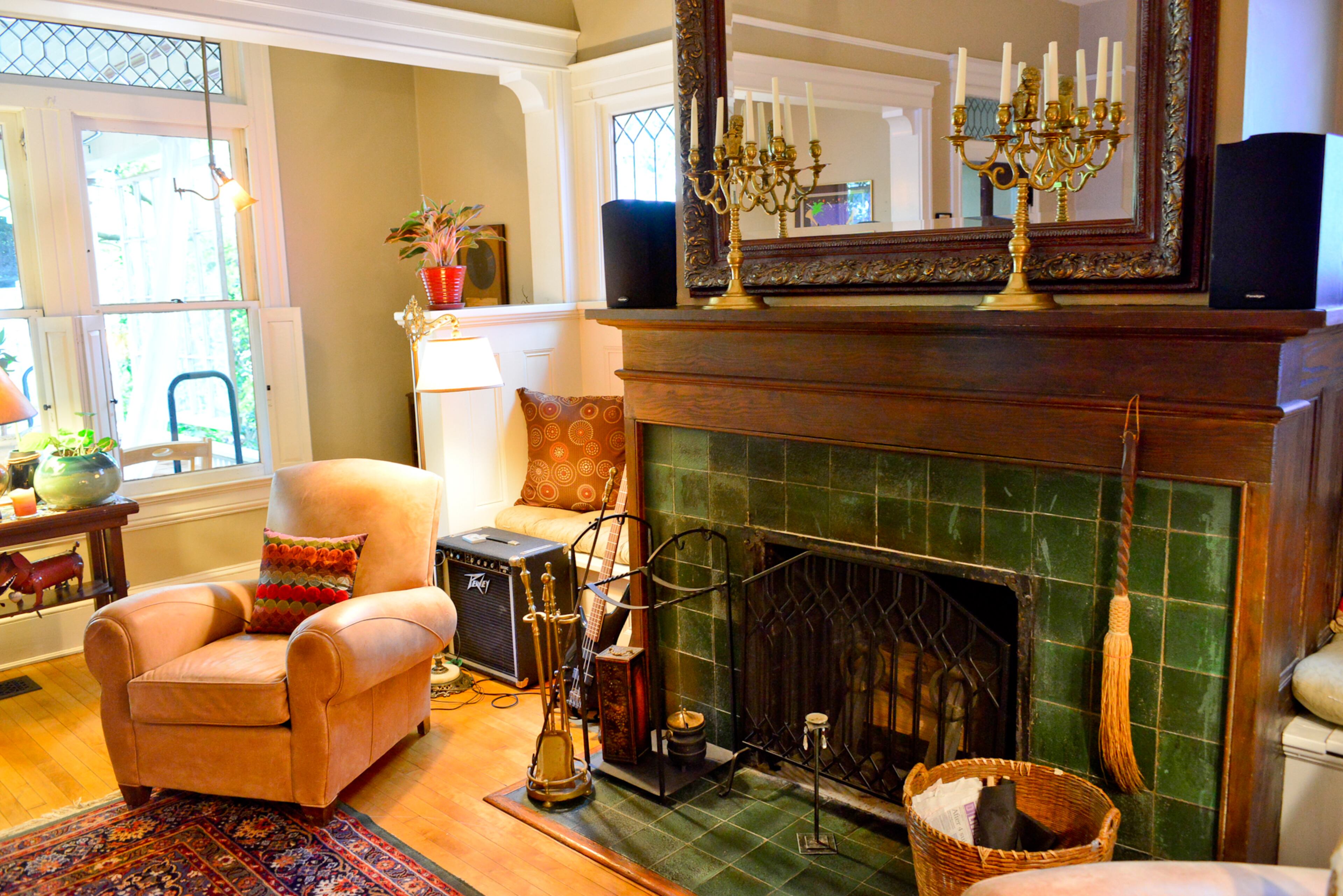 During this year's Inman Park Tour of Homes, a visitor told them the green tile surrounding the fireplace in the living room and dining room is rare. A built-in bench near the fireplace offers a cozy nook, next to paintings by Sandra Meyer.