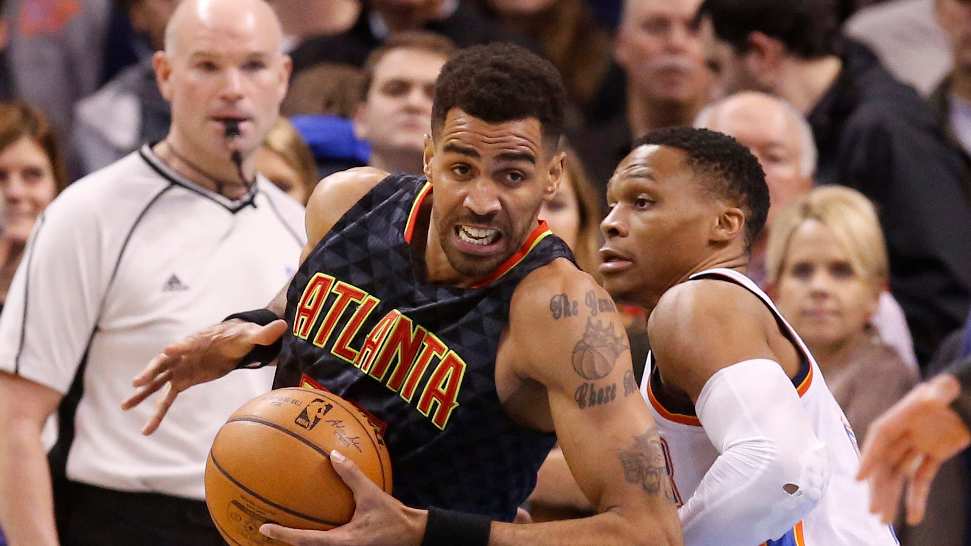 Atlanta Hawks forward Thabo Sefolosha, left, drives around Oklahoma City Thunder guard Russell Westbrook, right, in the first half of an NBA basketball game in Oklahoma City, Monday, Dec. 19, 2016. (AP Photo/Sue Ogrocki)
