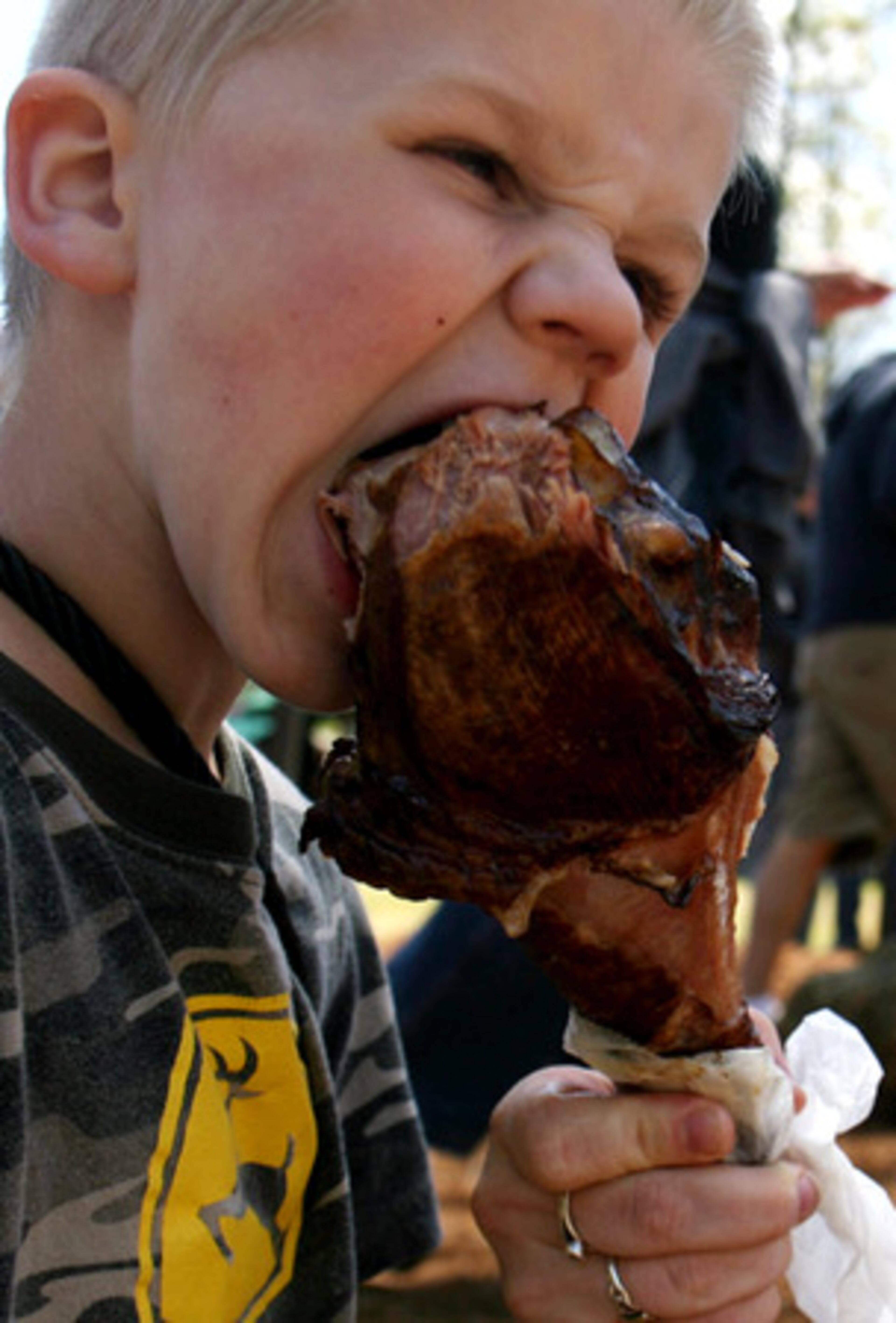 Logan Hilton, 5, of Gainesville, takes a bite from a turkey leg at the Georgia Renaissance Festival in Fairburn on Sunday. After a swallow, Logan said, "It's all good to me." Guests enjoyed festival food including fried Coca-Cola, fried mac 'n' cheese and fish 'n' chips.