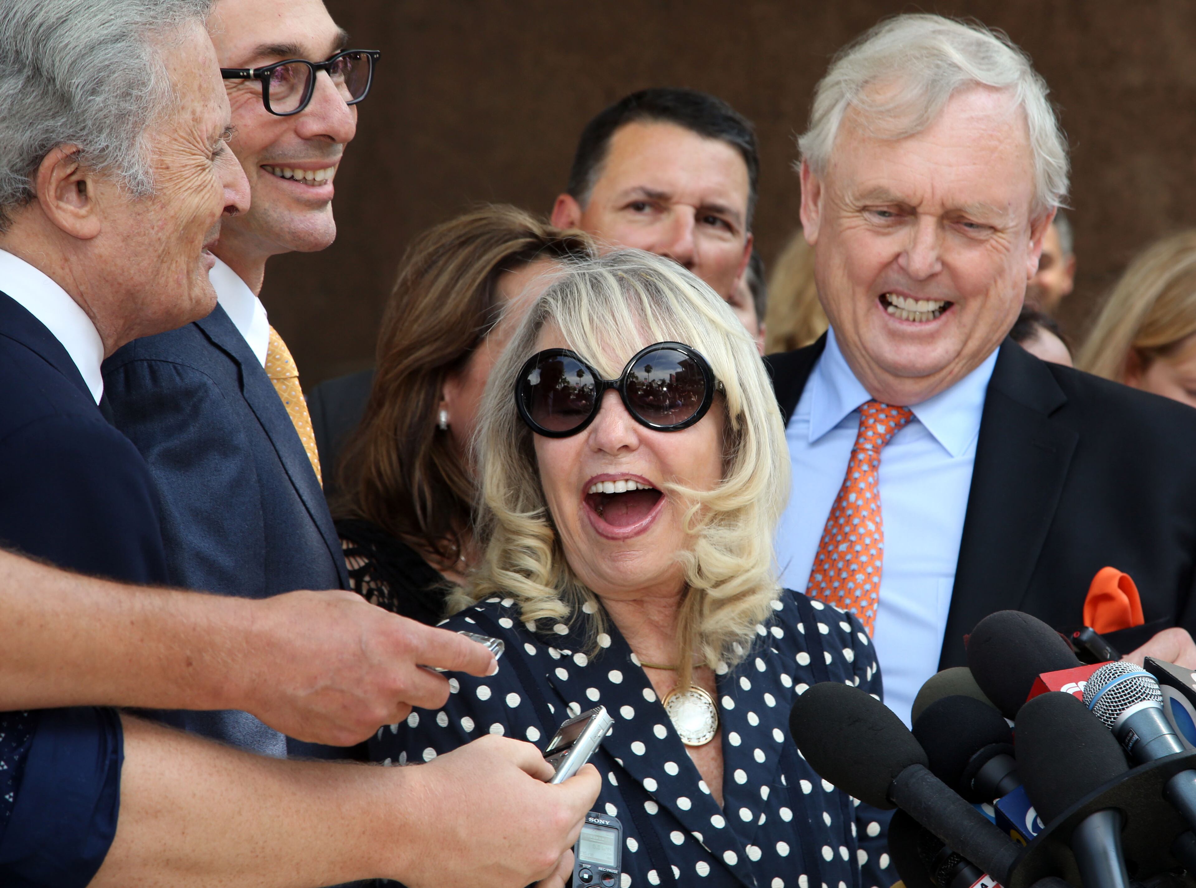 With her attorney Pierce O'Donnell, right, Shelly Sterling, center, talks to reporters after a judge ruled in her favor and against her estranged husband, Los Angeles Clippers owner Donald Sterling, in his attempt to block the $2 billion sale of the NBA basketball team, outside Los Angeles Superior Court Monday, July 28, 2014.