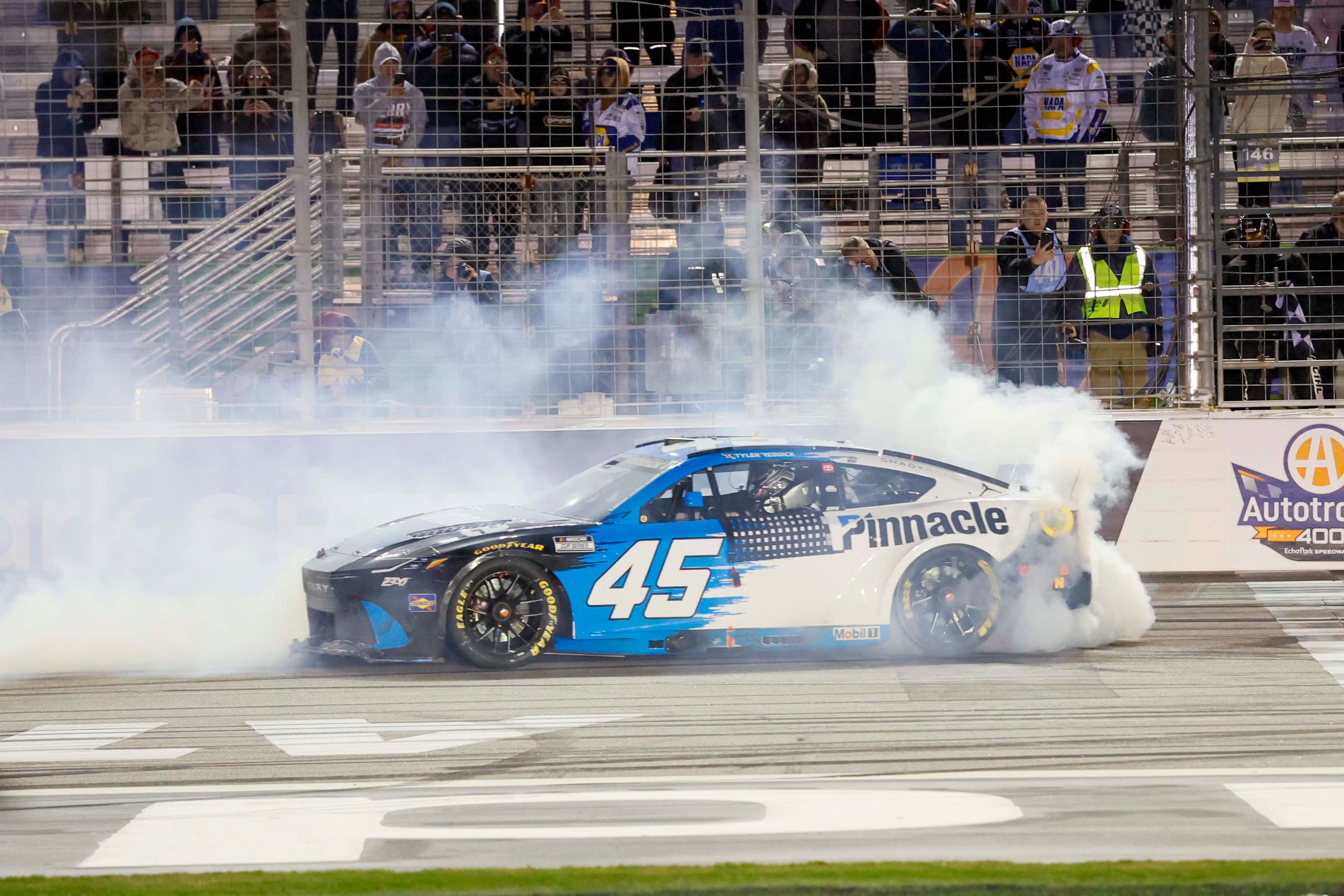 23XI Racing driver Tyler Reddick (45) spins his wheels to celebrate after winning the NASCAR Autotrader 400 at EchoPark Speedway on Sunday, Feb. 22, 2026, in Hampton, Ga. This marks Reddick’s second consecutive victory.(Miguel Martinez/AJC)