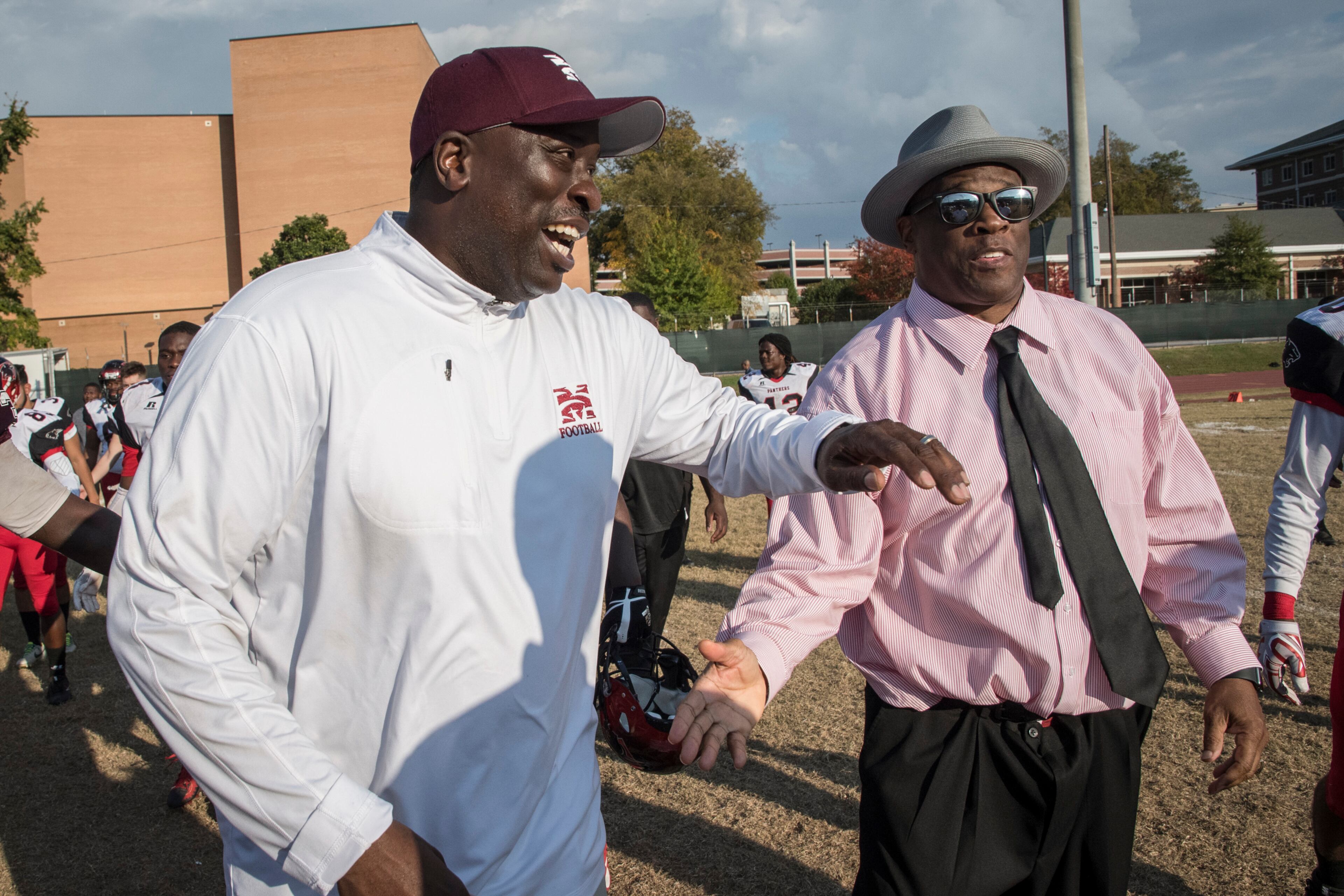 Morehouse head coach Rich Freeman, left, greets Clark Atlanta head coach Kevin Ramsey on the field after a college football game on Saturday, Nov. 4, 2017, in Atlanta. Morehouse won 40-0. (John Amis)