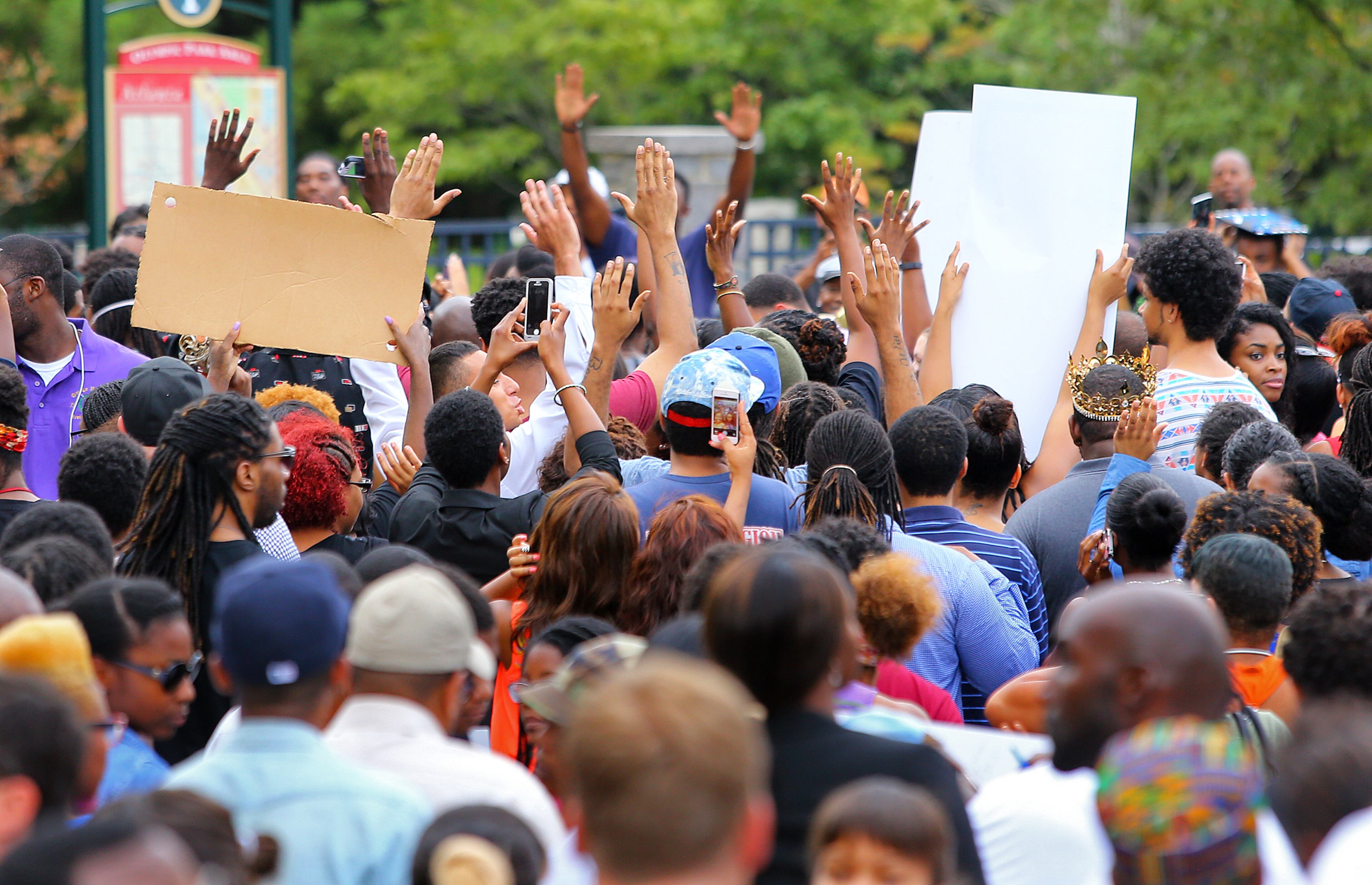 081814 Atlanta: Protesters fill Marietta Street as they begin to march with their hands up during a rally for Mike Brown and Ferguson outside the CNN Center drawing a thousand or more on Monday, August 18, 2014, in Atlanta. CURTIS COMPTON / CCOMPTON@AJC.COM
