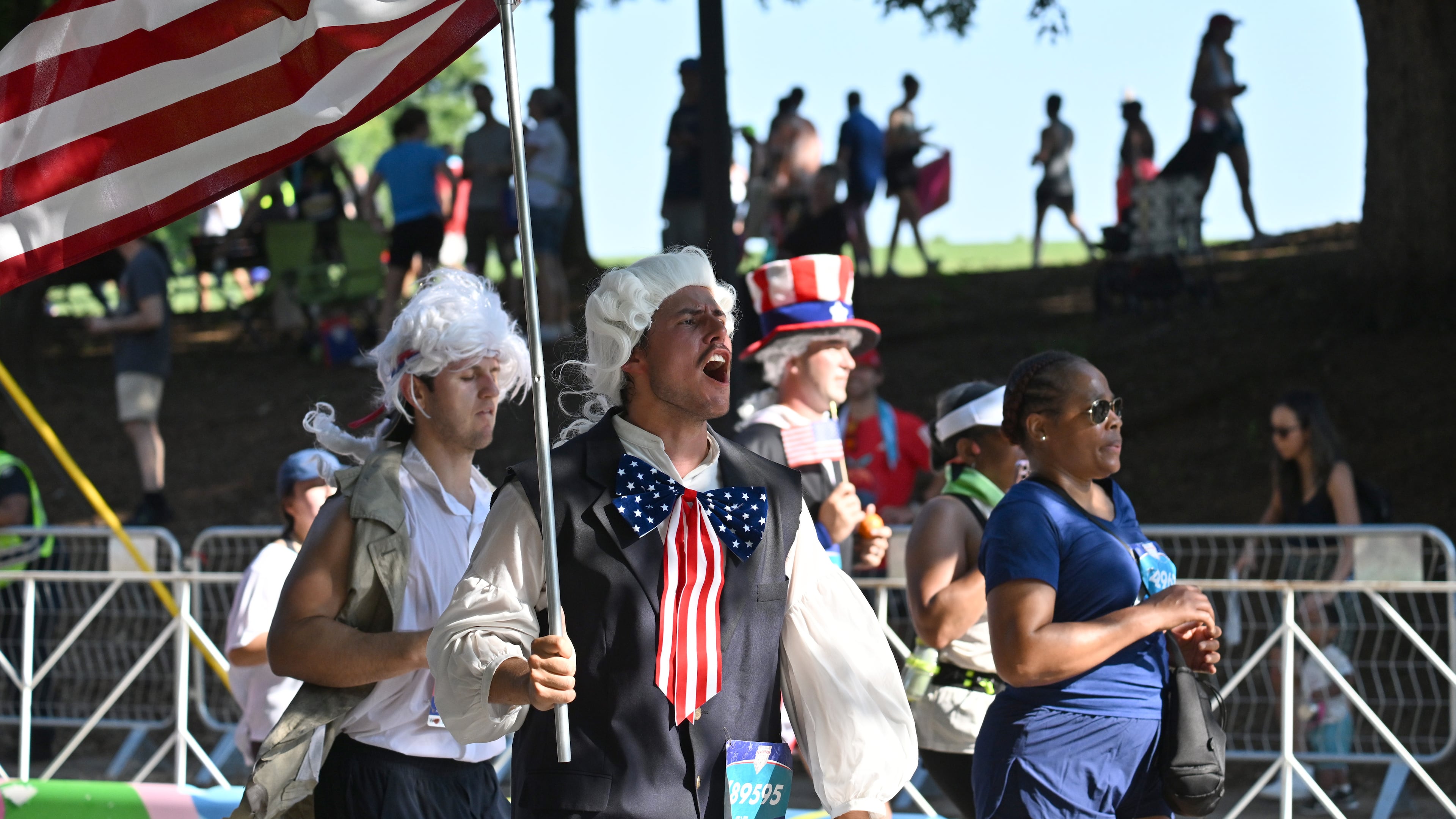 Patriotic runners cross the finish line at last year's Peachtree Road Race. (Hyosub Shin/AJC 2025)