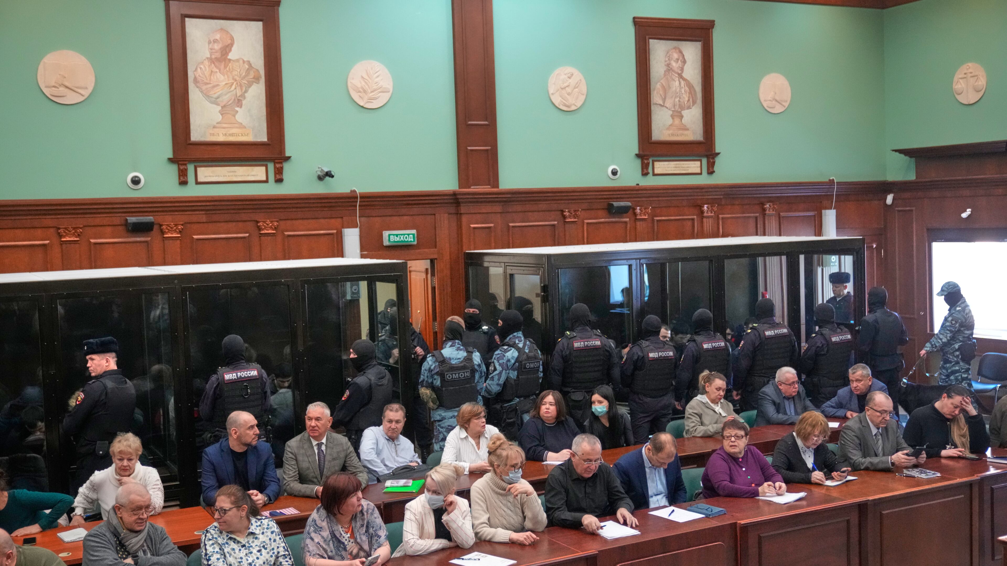Men tried on the charges of involvement in a terror attack at the Crocus City Hall in March 2024 listen to the verdict in a glass cage at the Second Western District Military Court in Moscow, Russia, Thursday, March 12, 2026. (AP Photo/Pavel Bednyakov)