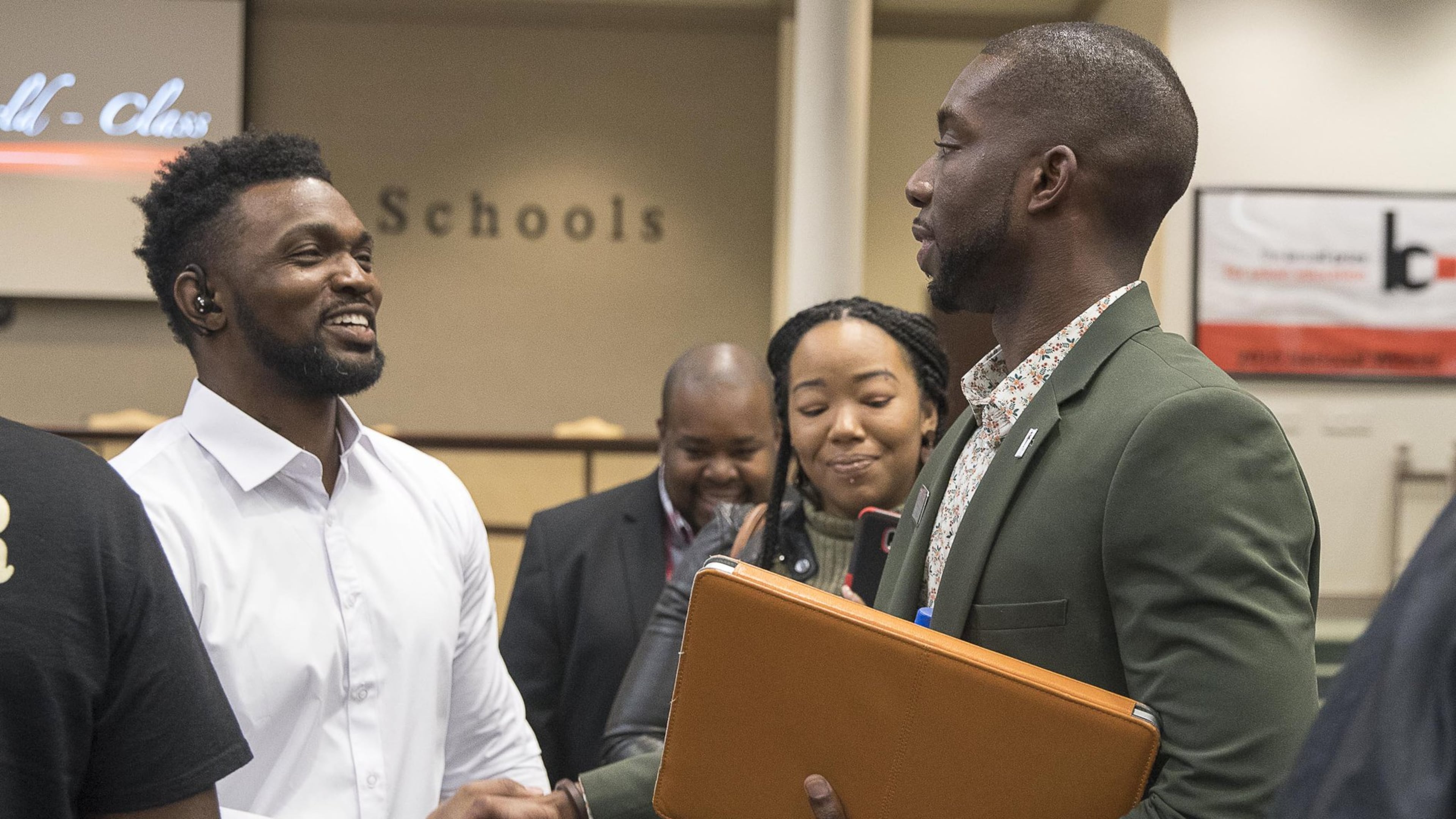 Gwinnett County school board member Everton Blair, Jr. (right) greets Tristan King (left), a father of two Gwinnett County Public School students, after a Gwinnett County School Board meeting in Suwannee, Thursday, March 21, 2019. On Feb. 28, King says his daughter, a kindergartner, was lost — left behind when the school bus took other kids home — at Norton Elementary. During the meeting he asked the board to fire the principal and others. ALYSSA POINTER/ALYSSA.POINTER@AJC.COM