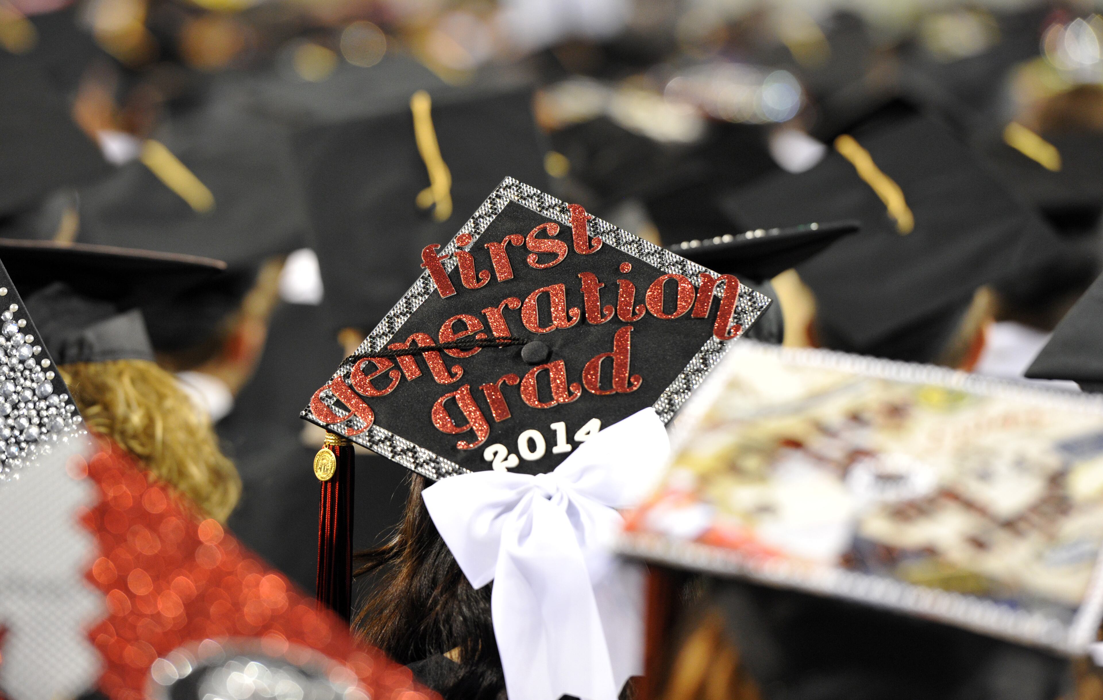 University of Georgia graduates wear decorated mortar boards during the Georgia 2014 Spring undergraduate commencement at Sanford Stadium in Athens on Friday night, May 9, 2014. HYOSUB SHIN / HSHIN@AJC.COM