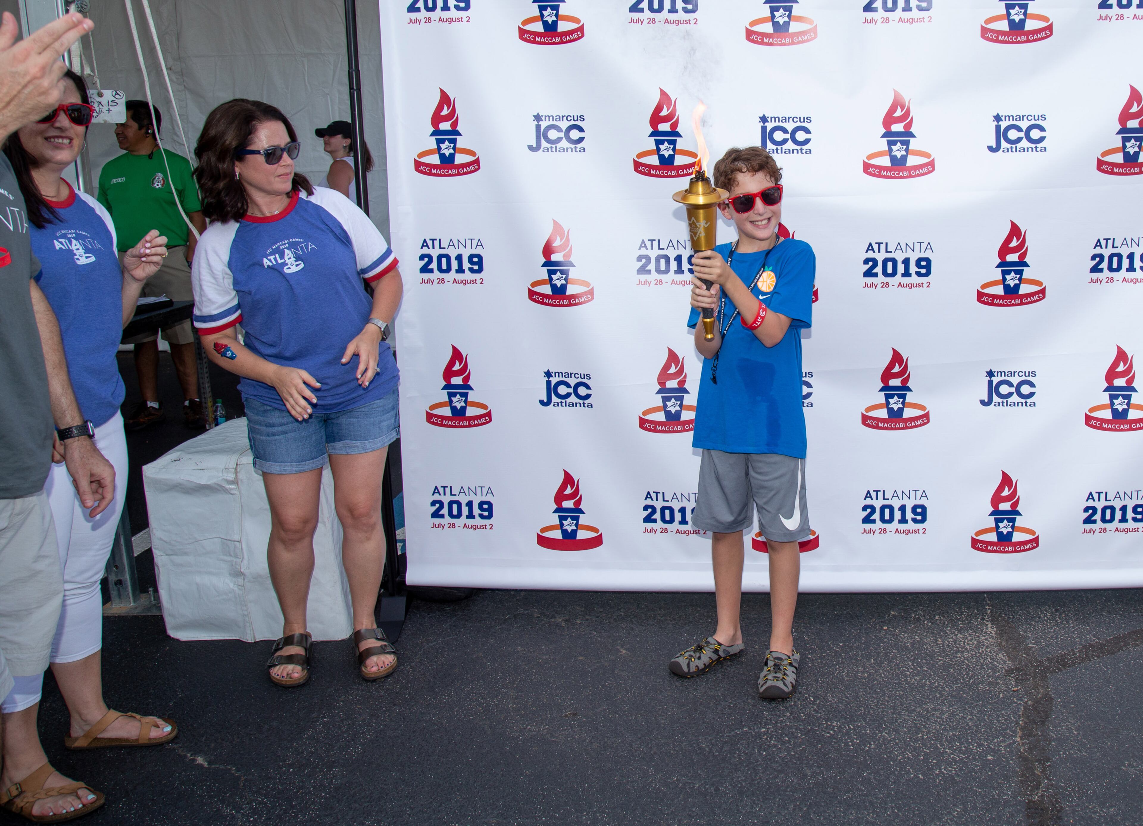 Blake Cohen gets his photograph taken with the torch after the Ignite Maccabi torch lighting ceremony that officially kicks off the 2019 JCC Maccabi Games at the Marcus Jewish Community Center of Atlanta. The 2019 JCC Maccabi Games will be held in Atlanta July 28 through August 2, 2019. (Photo: STEVE SCHAEFER / SPECIAL TO THE AJC)