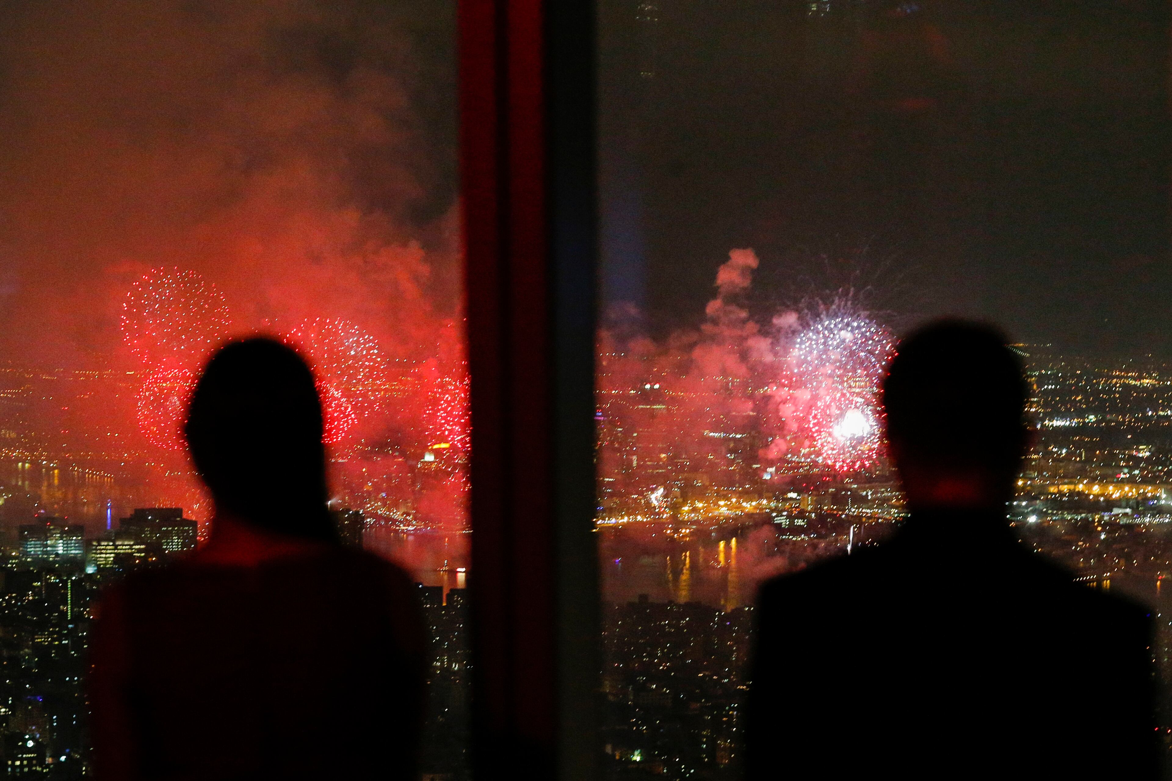 NEW YORK, NY - JULY 4: People look at The 2015 Macy's 4th of July Fireworks from the One World Trade Center Observatory on July 4, 2015 in New York City. The celebrations mark the 239th Independence Day. (Photo by Eduardo Munoz Alvarez/Getty Images)