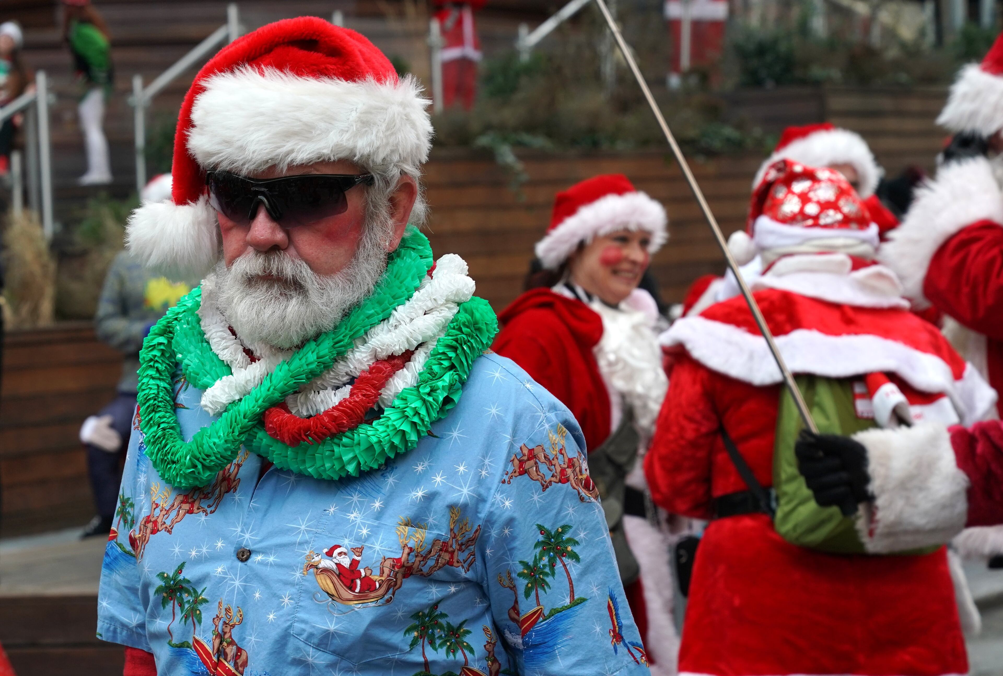 Revelers dressed as Santa Claus or in festive costumes arrive for the start of SantaCon 2018 in New York City December 8, 2018. - SantaCon the official Santa pub crawl happens in bars all across the world. (Photo by TIMOTHY A. CLARY / AFP)