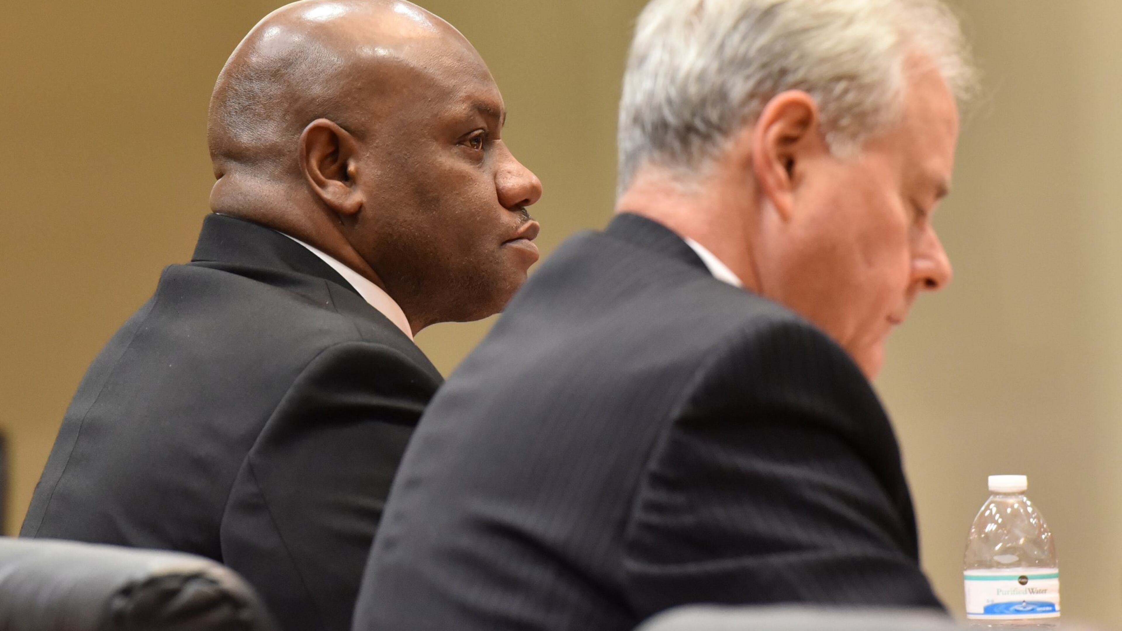 Former DeKalb County Police Sgt. Anthony Remone Robinson, left, listens to testimony against him on Thursday, Feb. 18, 2016, in DeKalb County Superior Court. (Brant Sanderlin/bsanderlin@ajc.com)
