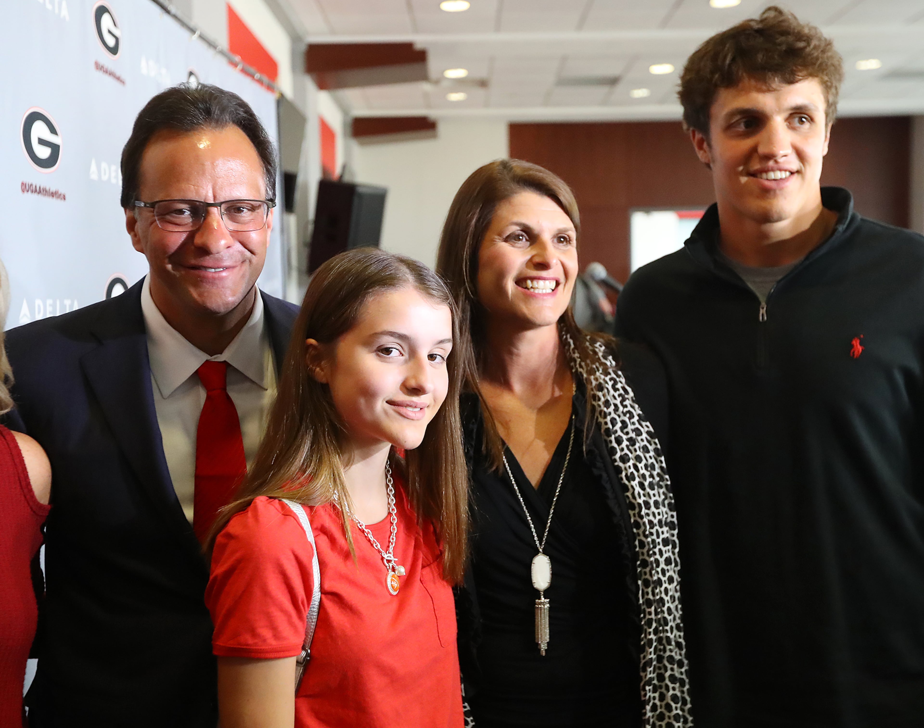 March 16, 2018 Athens: Tom Crean, his wife Joani (the former Joani Harbaugh), son Riley, 18, and daughter Ainsley, 12, gather for a family photo after Crean was introduced as the new men's basketball head coach at the University of Georgia on Friday, March 16, 2018, at Stegeman Coliseum in Athens. Curtis Compton/ccompton@ajc.com