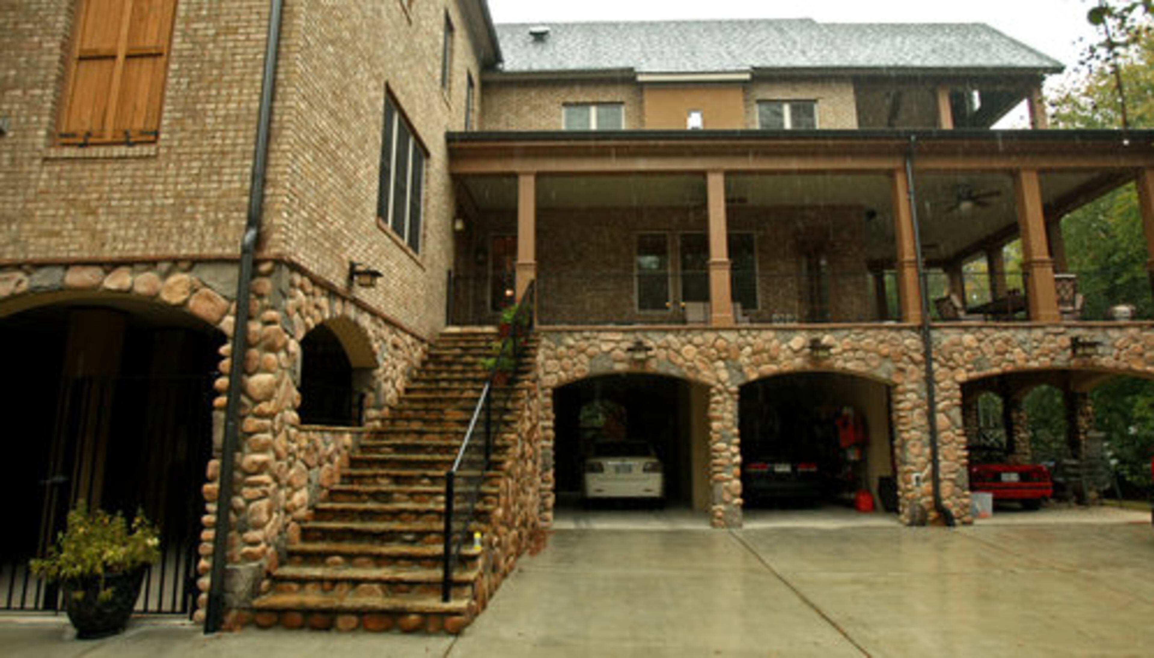 Charlie and Christine Bradley redid their house with a faux ground floor, making it appear that the house has three stories. The bottom floor serves as a garage and raises the living space above possible flood waters.