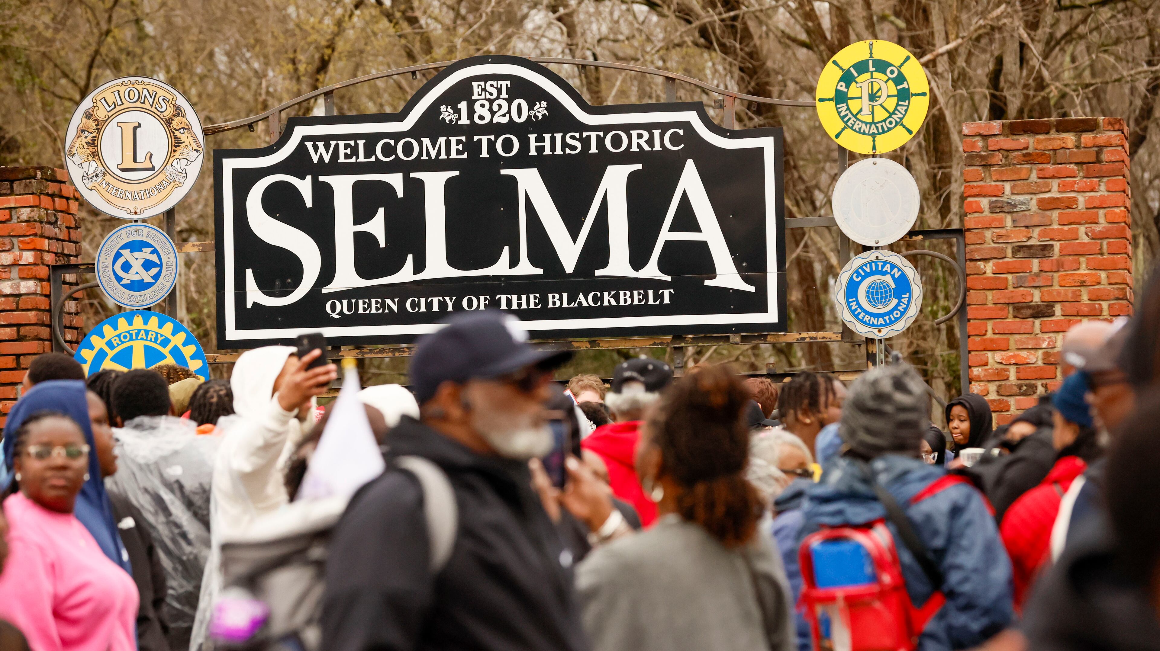 Attendees to the rally take pictures in front of the City of Selma sign during the 60th anniversary of Bloody Sunday, on Sunday, March 9, 2025. (Miguel Martinez/ AJC)
