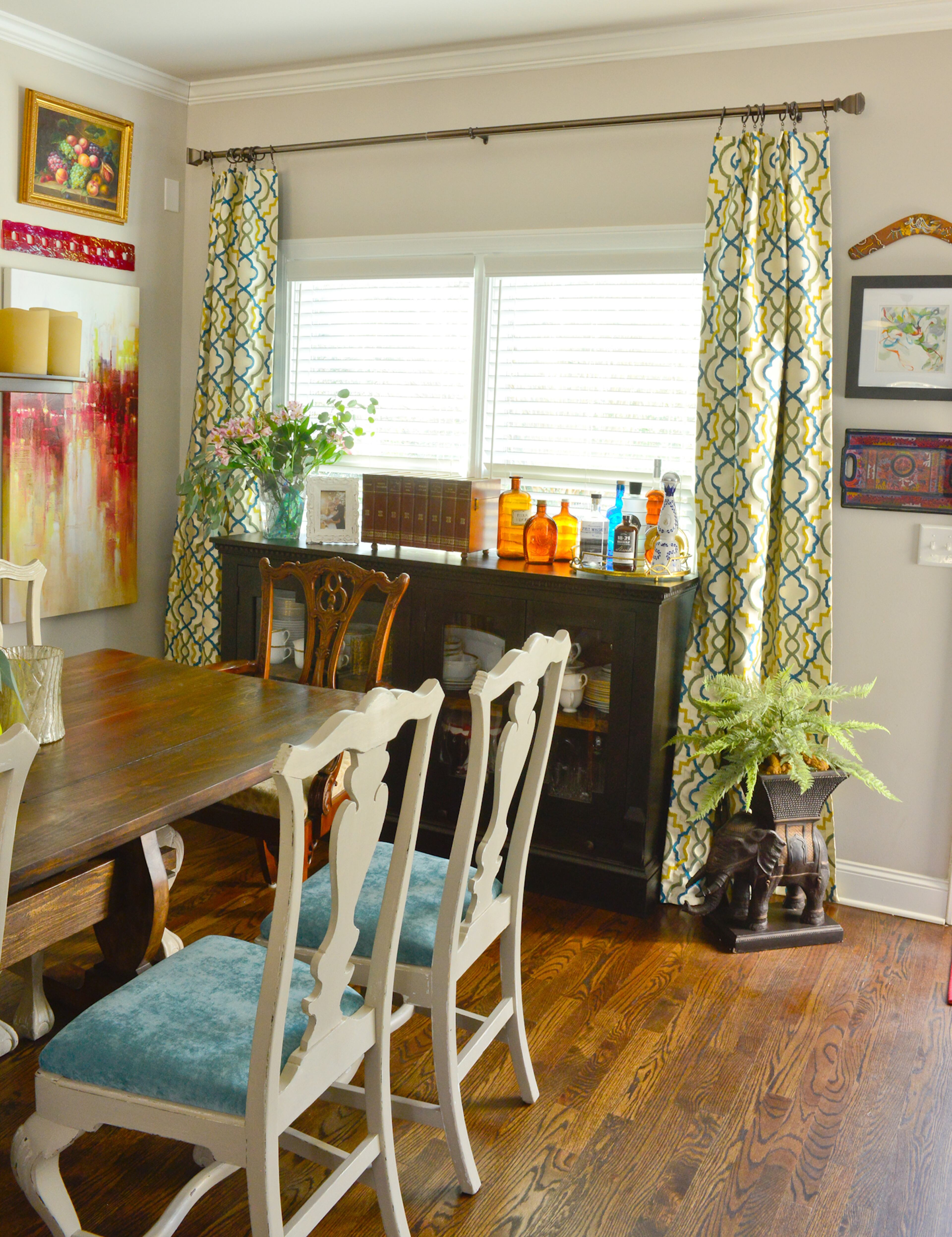 A custom sideboard in Jennifer and Will Franklin's dining room has a glass front and dentil molding at the top. The sideboard, one of a few pieces made by a craftsman contracted through Home Deals in Jefferson, Ga., is framed by custom curtains using fabric with yellow, blue and gray details from Hancock Fabrics. Text by Lori Johnston and Keith Still/Fast Copy News Service.