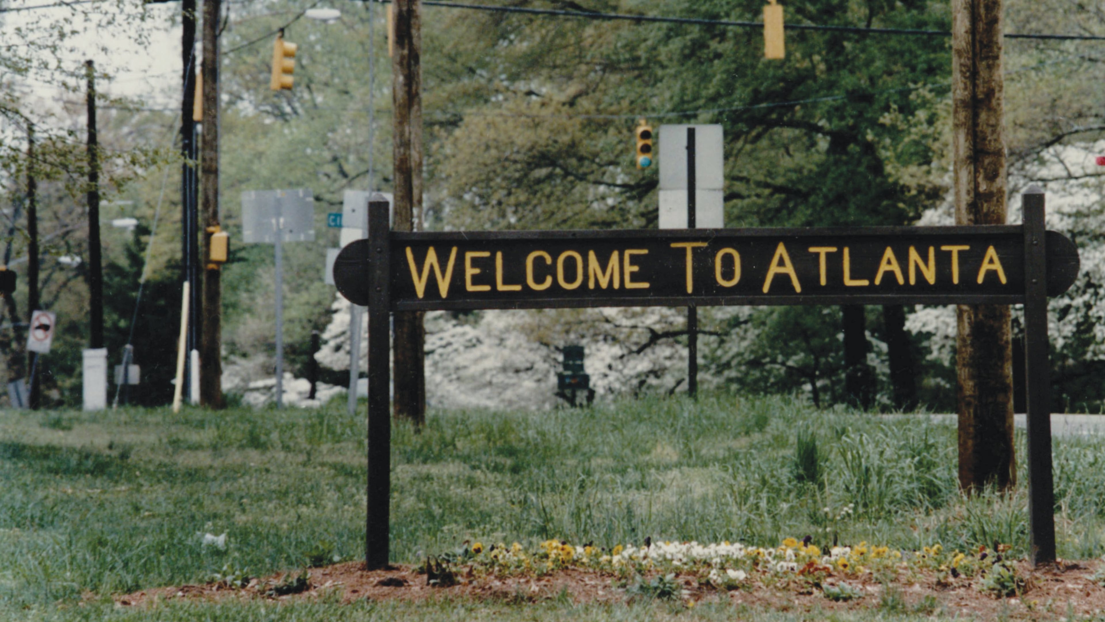 A rustic sign on Ponce de Leon Avenue at the city's edge read “Welcome to Atlanta” on one side and “Leaving Atlanta” on the other side. The sign stood at the edge of the Olmsted Linear Park next to a city-limits marker and might have been updated over the years. (Kimberly Smith/AJC Archive at GSU Library 1993)