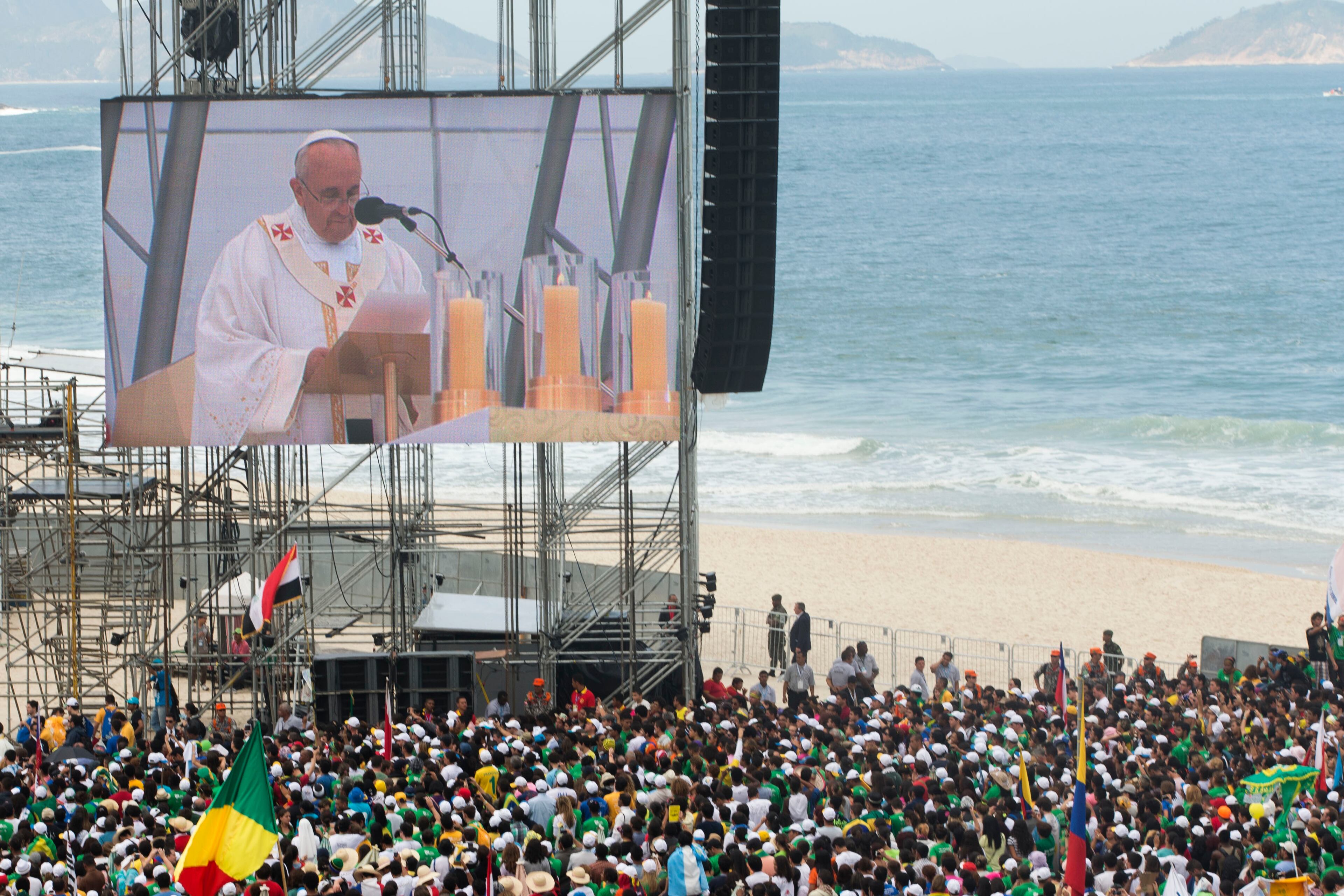 Pope Francis is seen on a large screen as he celebrates the World Youth Day's concluding Mass on Copacabana beach, in Rio de Janeiro, Brazil, Sunday, July 28, 2013. (AP Photo/Victor R. Caivano)