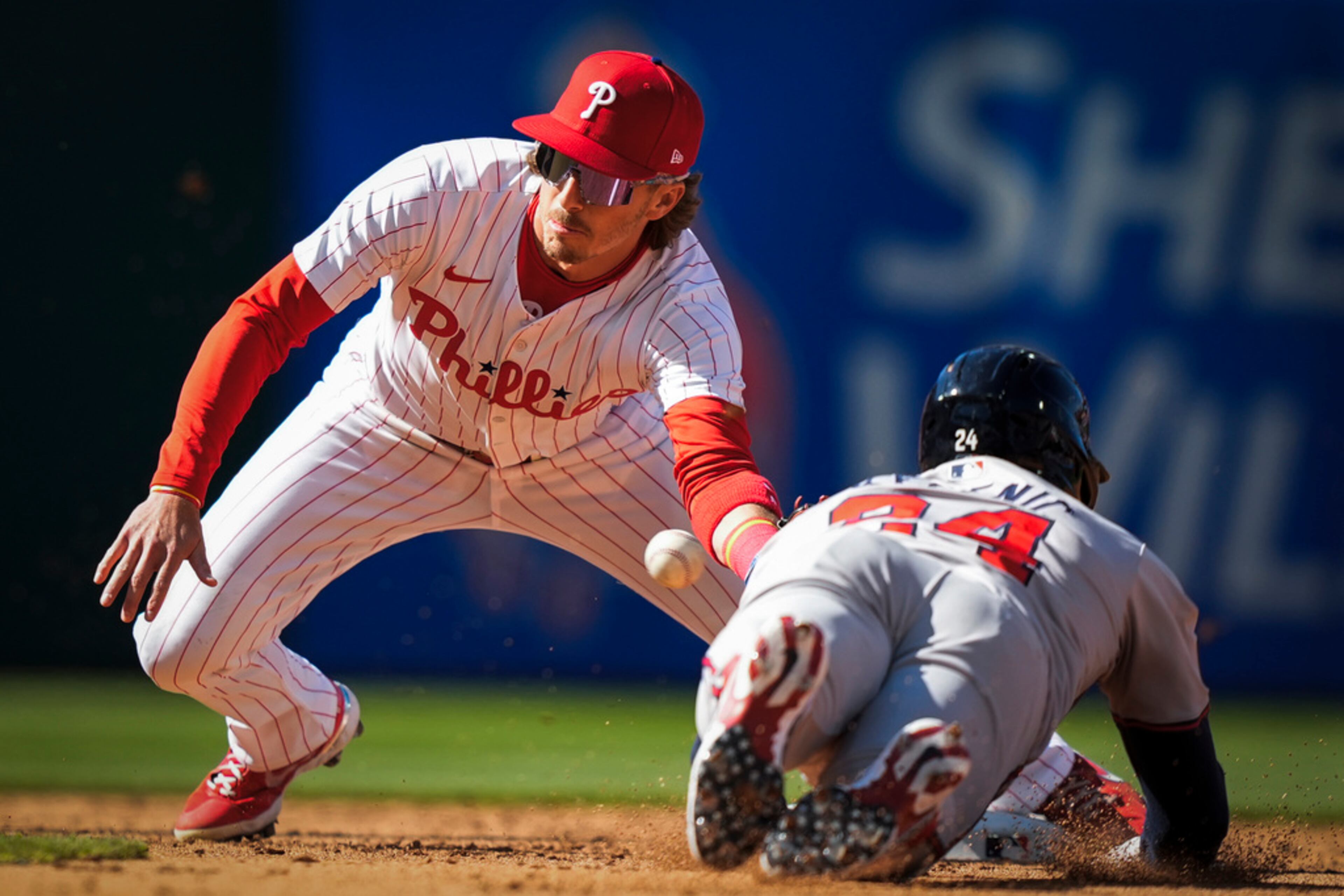 Philadelphia Phillies' Bryson Stott tags out Atlanta Braves' Jarred Kelenic attempting steal second during the third inning of an opening day baseball game, Friday, March 29, 2024, in Philadelphia. (AP Photo/Matt Slocum)