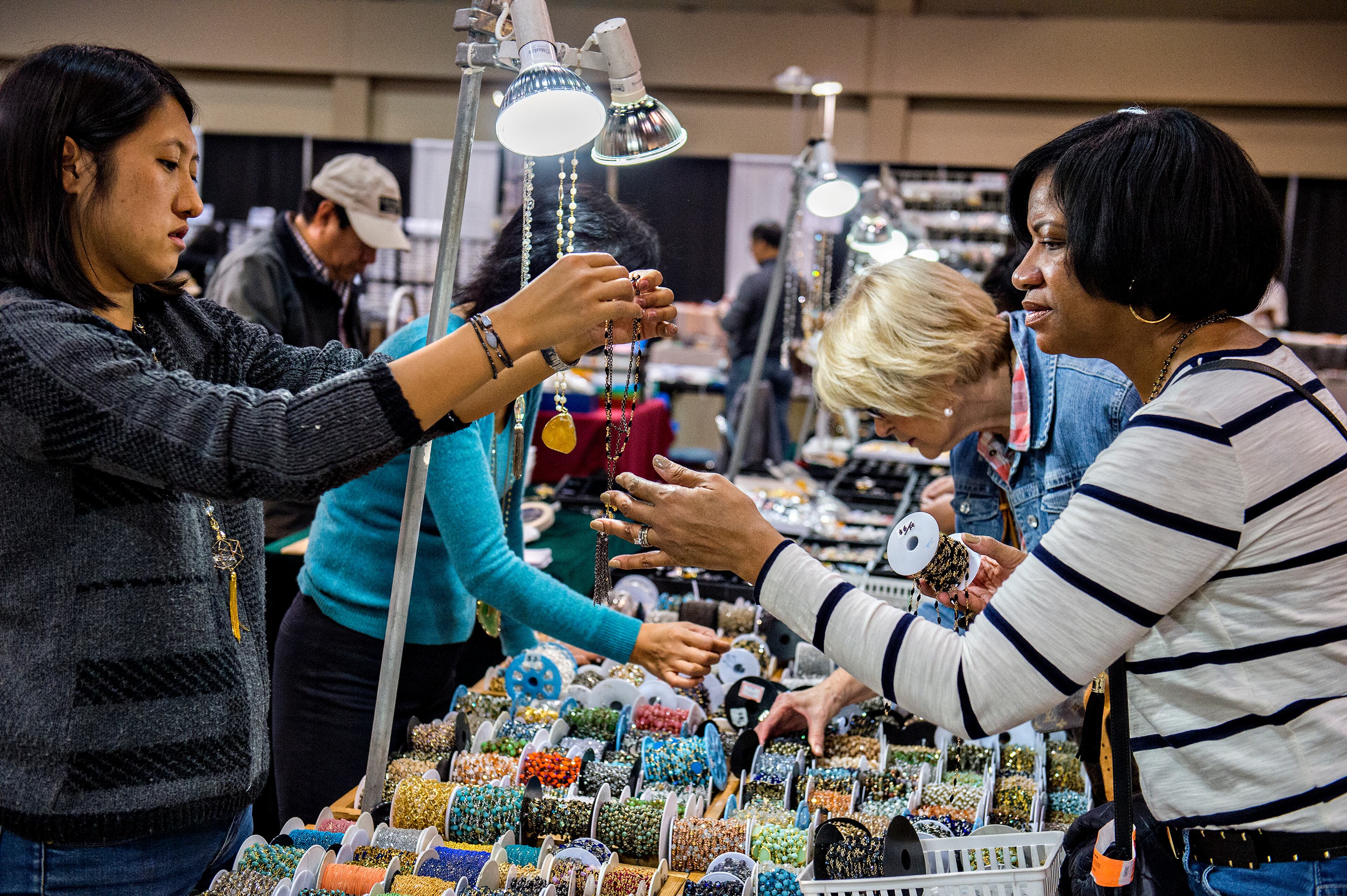 Wenwen Zhao (left) shows Charlotte Starks a strand of bead as she shops during the Intergalactic Bead Show at the Infinite Energy Center in Duluth on Saturday, Feb. 6, 2016. Tens of thousands of beads were up for grabs for artists, crafters and jewelry lovers during the show. JONATHAN PHILLIPS / SPECIAL
