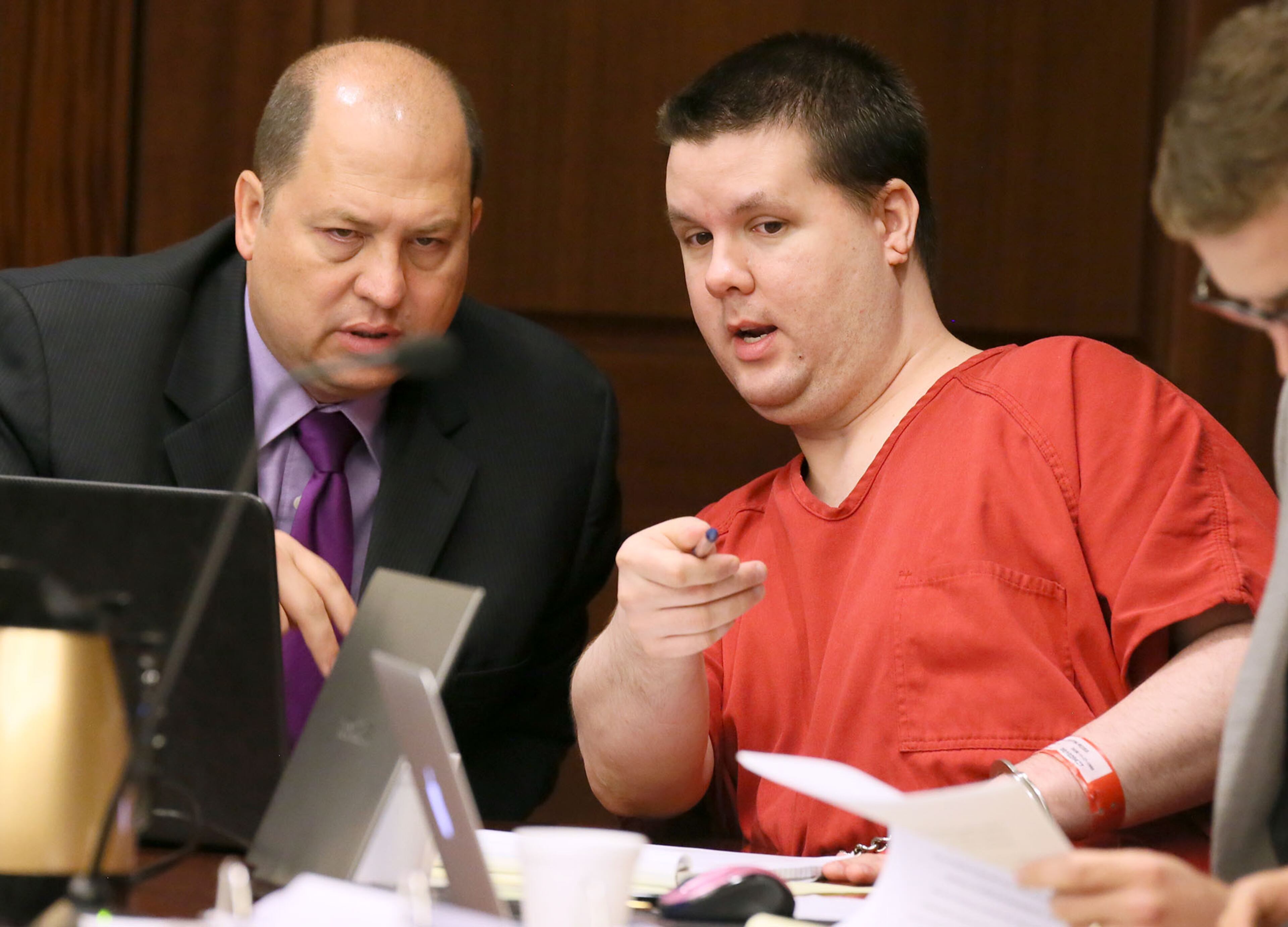 Justin Ross Harris, right, motions to a image on a laptop on the defendant's tables to one of his attorneys, T. Bryan Limpkin, on Tuesday, Sept. 15, 2015, as the pre-trial motion hearings continue before Cobb County Superior Court Judge Mary Staley in Marietta, Ga. Harris is accused of killing his 22-month-old son Cooper by leaving him in a hot car in 2014. (Kelly J. Huff/Marietta Daily Journal via AP, Pool)
