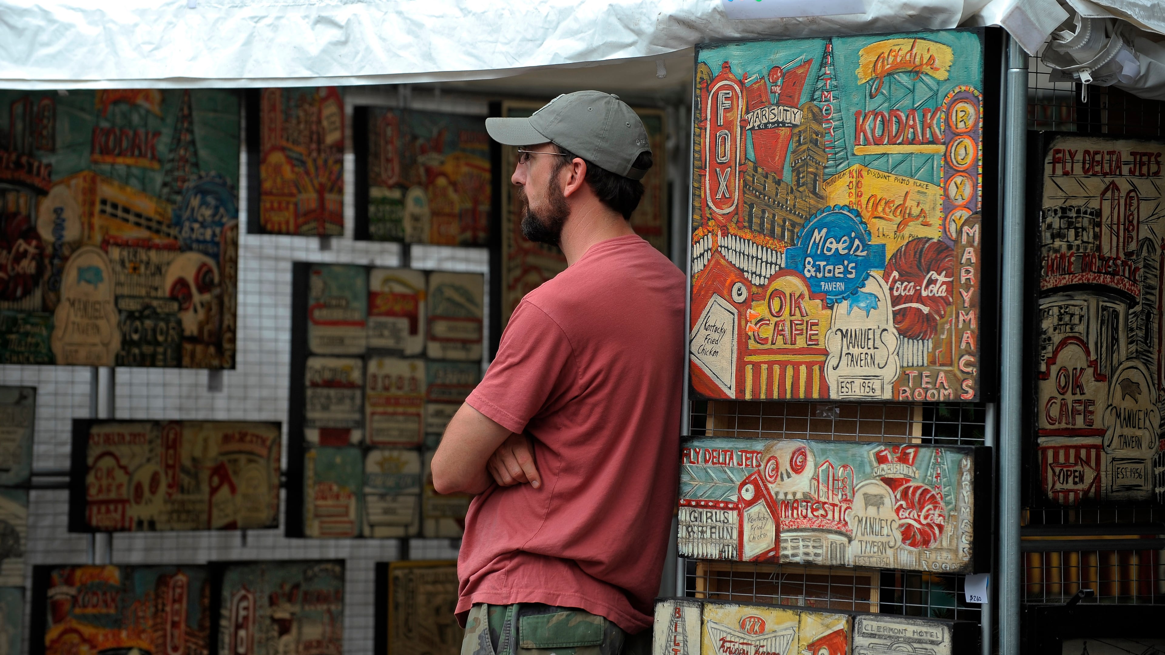 Will Coil of Smyrna keeps watch over wife Maria Louise Coil's local landmark art at the Virginia-Highland Summerfest. (Courtesy of David Tulis)