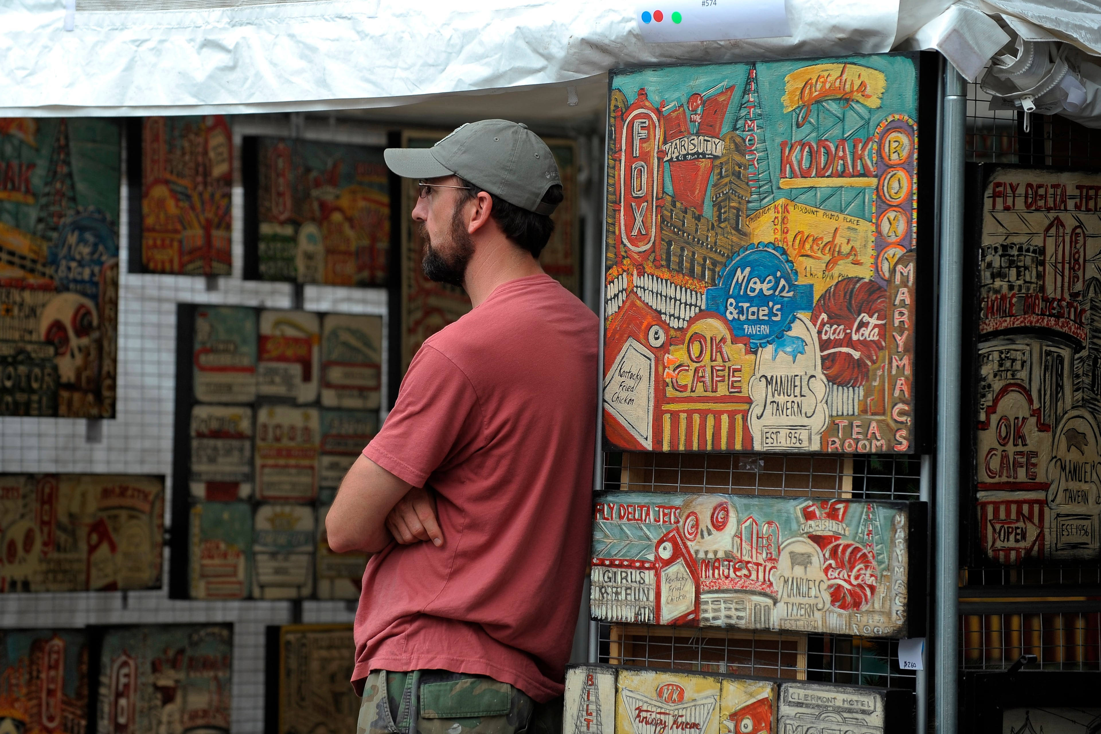 Will Coil of Smyrna keeps watch over wife Maria Louise Coil's local landmark art at the Virginia-Highland Summerfest. (Courtesy of David Tulis)