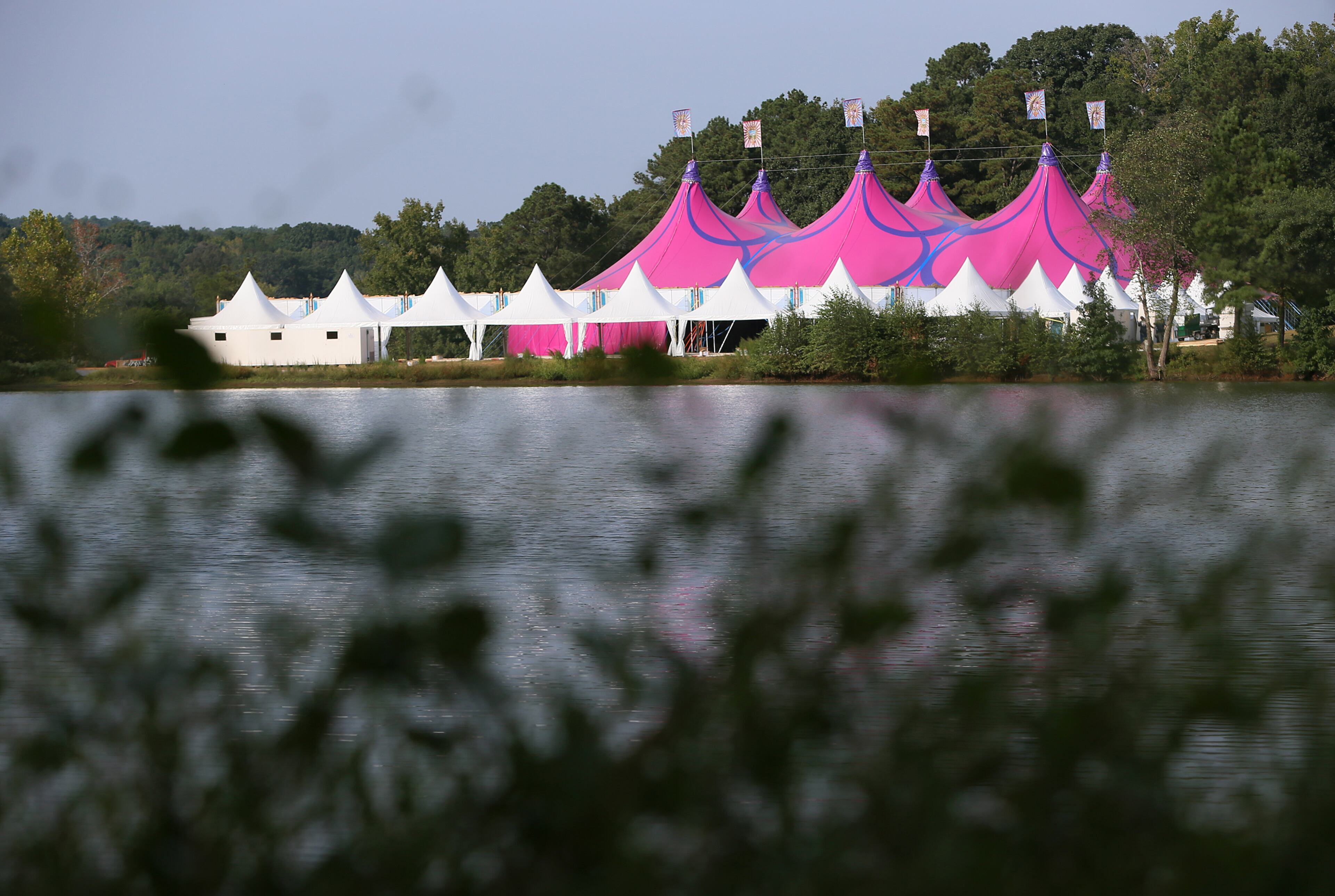One of eight stages, this one inside a tent, nears completion beside one of the many lakes at the 500 acre TomorrowWorld Festival site on Wednesday, Sept. 18, 2013, in Fairburn.