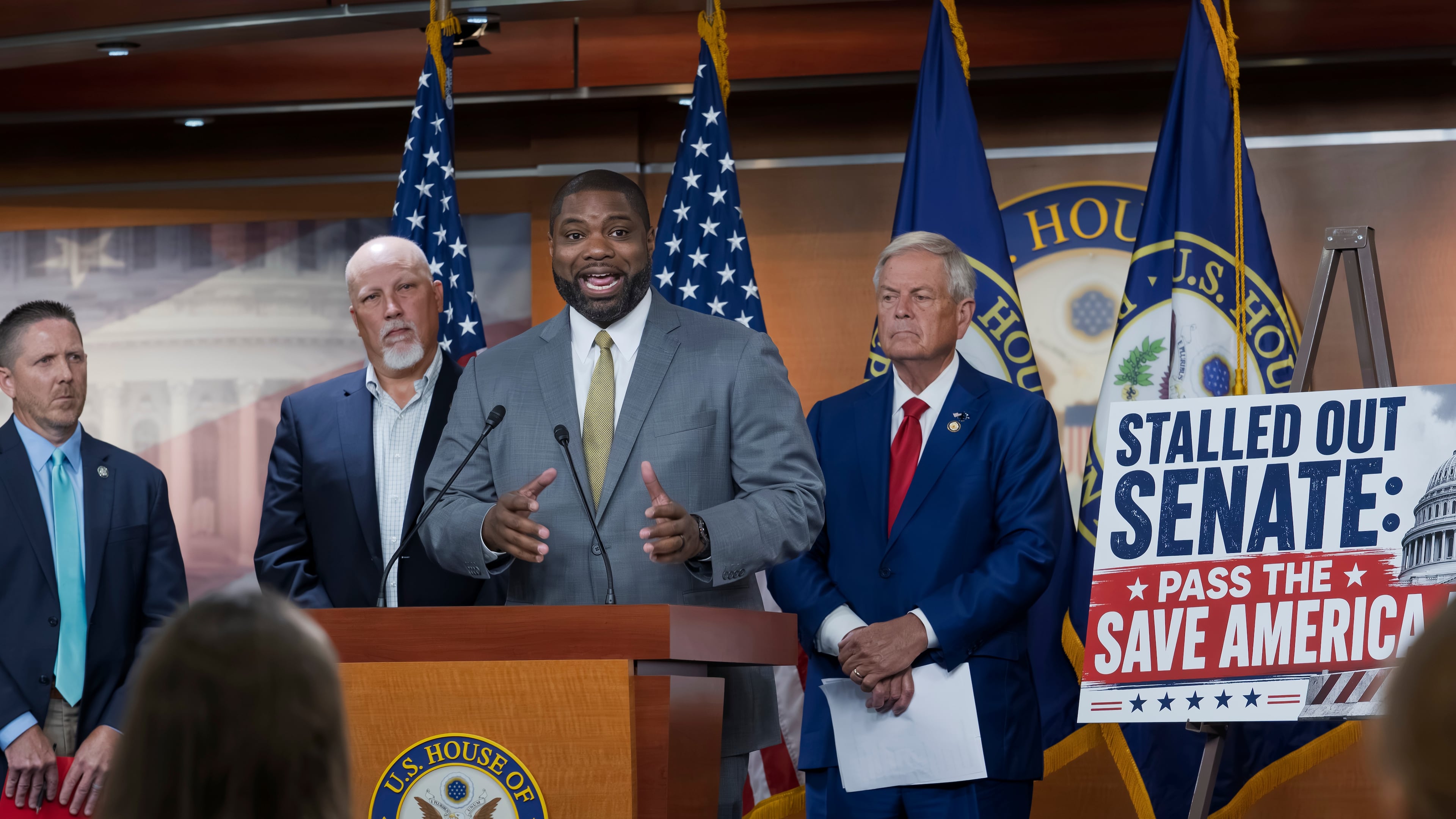 Rep. Byron Donalds, R-Fla., center, flanked by Rep. Chip Roy, R-Texas, left, and Rep. Ralph Norman, R-S.C., right, speaks to reporters as the conservative House Freedom Caucus slams the Senate for not acting on the Save America Act at the Capitol in Washington, Thursday, June 25, 2026. (AP Photo/J. Scott Applewhite)