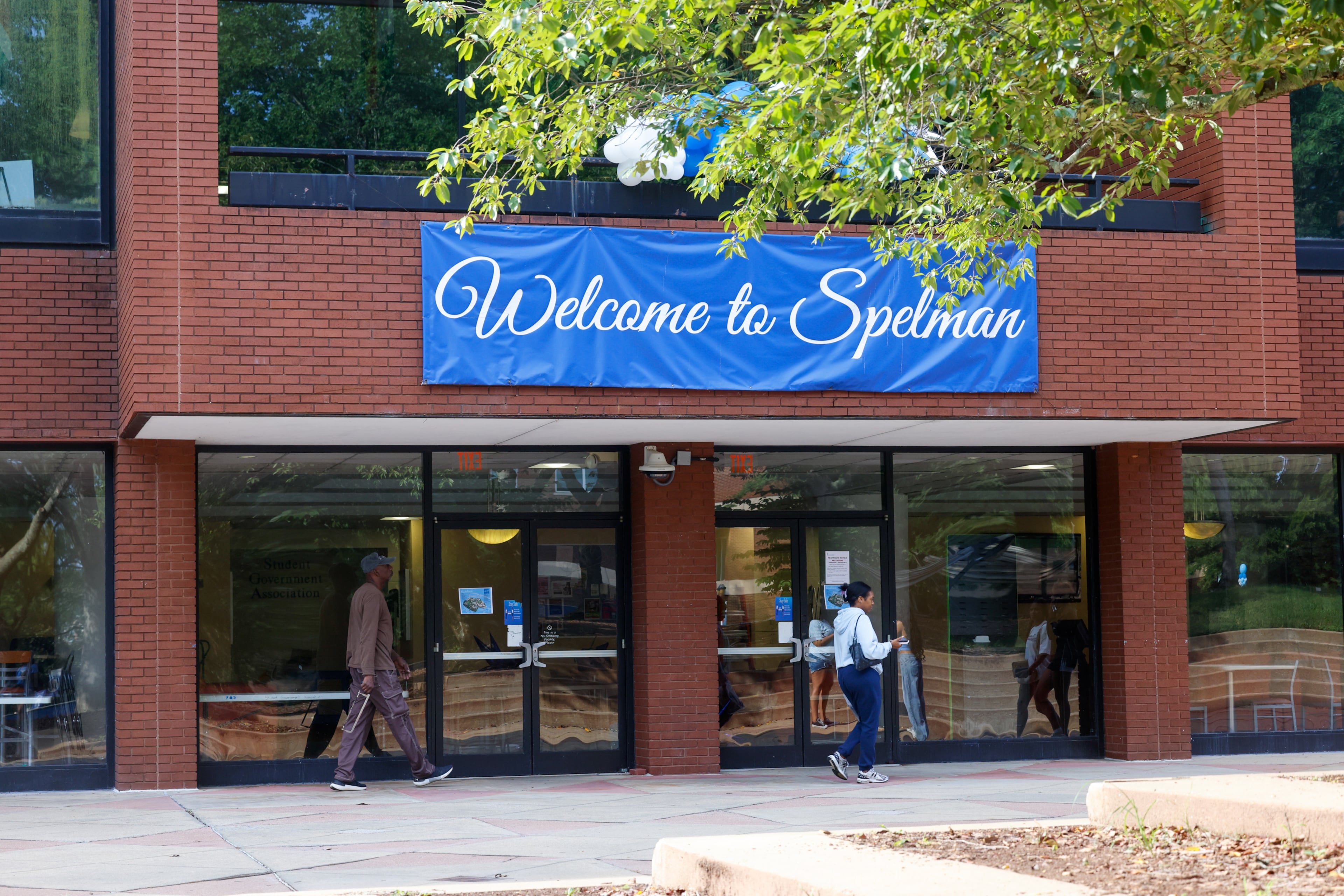 People walk past a sign that says “Welcome to Spelman” on move-in day at Spelman College in Atlanta on Aug. 12, 2026. (Arvin Temkar/AJC)