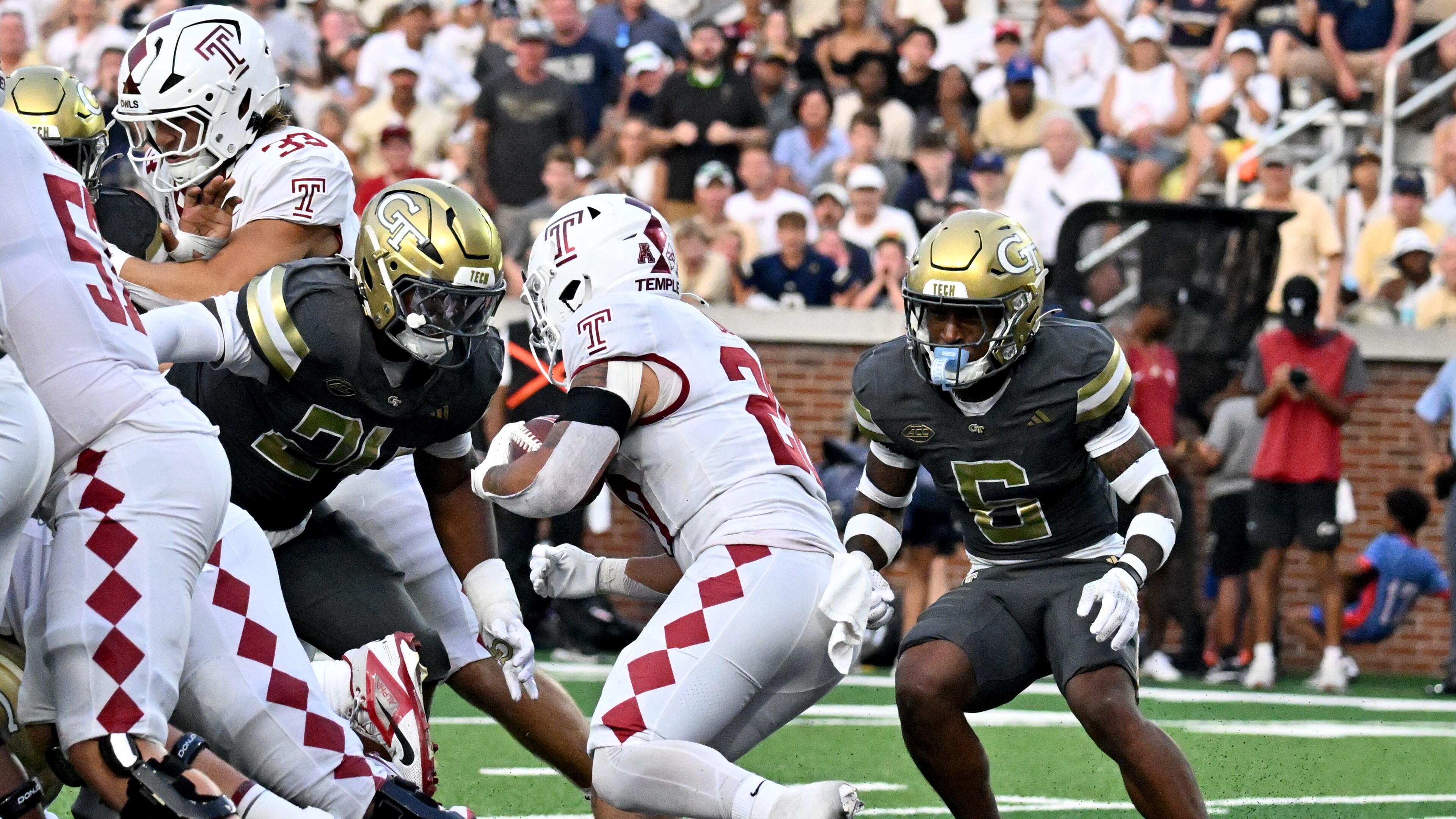 Georgia Tech defensive back Rodney Shelley (right) chases Temple running back Jay Ducker (center) in an NCAA college football game at Georgia Tech's Bobby Dodd Stadium, Saturday, Sept. 20, 2025 in Atlanta. (Hyosub Shin/AJC)