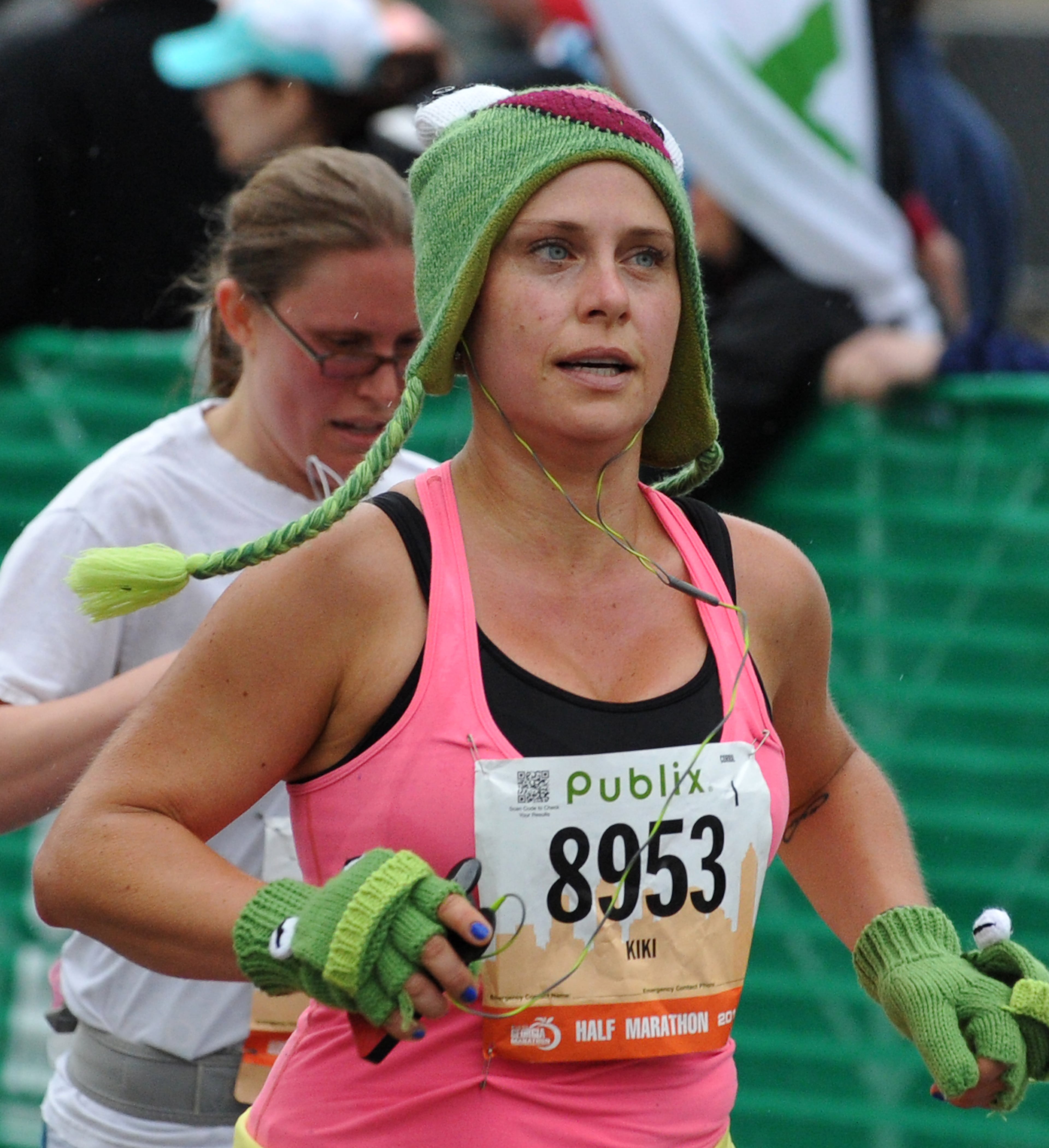 Kiki Aldonas, of Los Angeles, (8953) crosses the finish line at Centennial Olympic Park for the Publix Georgia Marathon & Half Marathon Sunday, March 23, 2014, in Atlanta. David Tulis / AJC Special