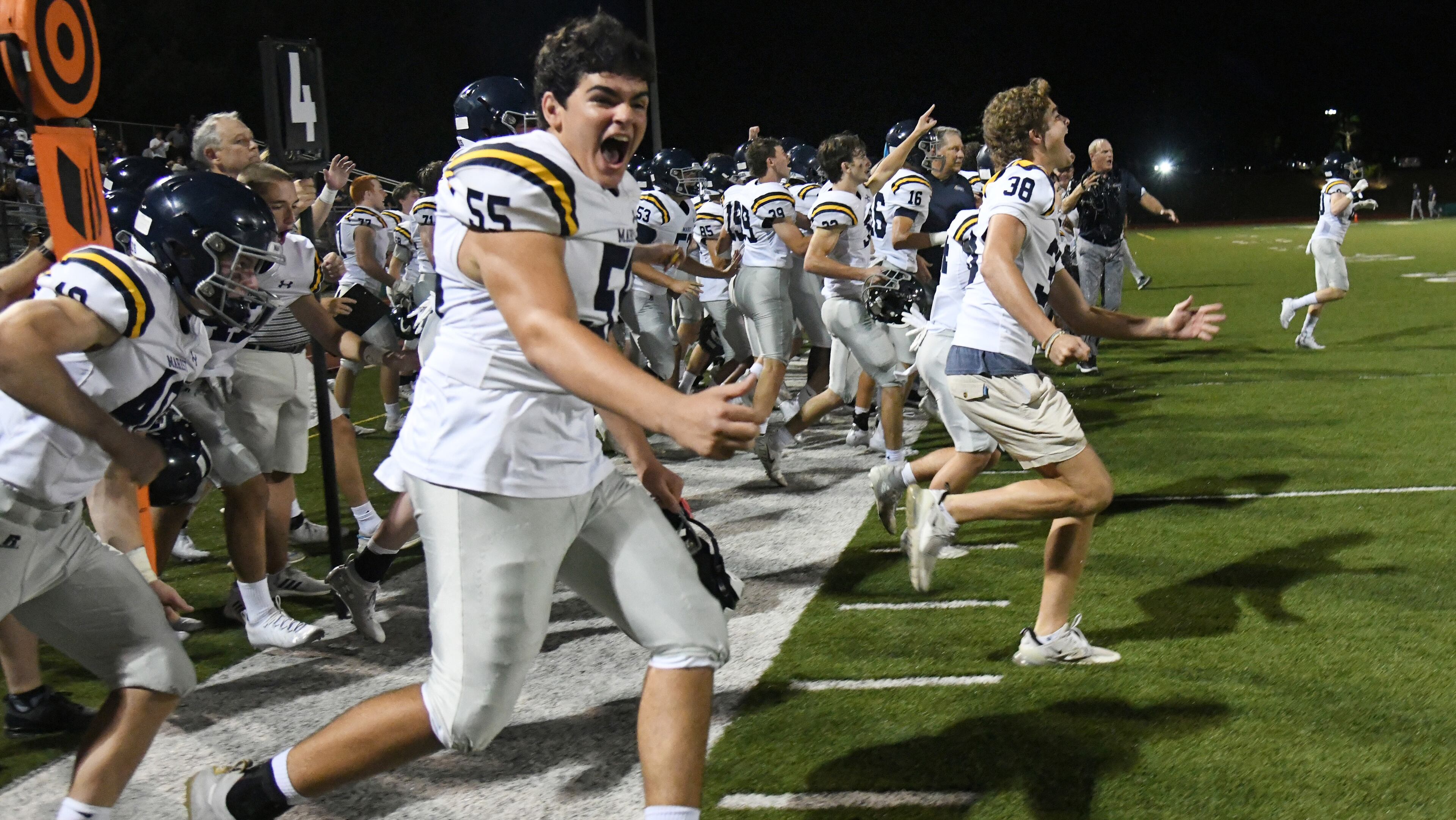 Time to celebrate: The Marist sideline celebrates after Friday's 28-13 victory over Blessed Trinity.