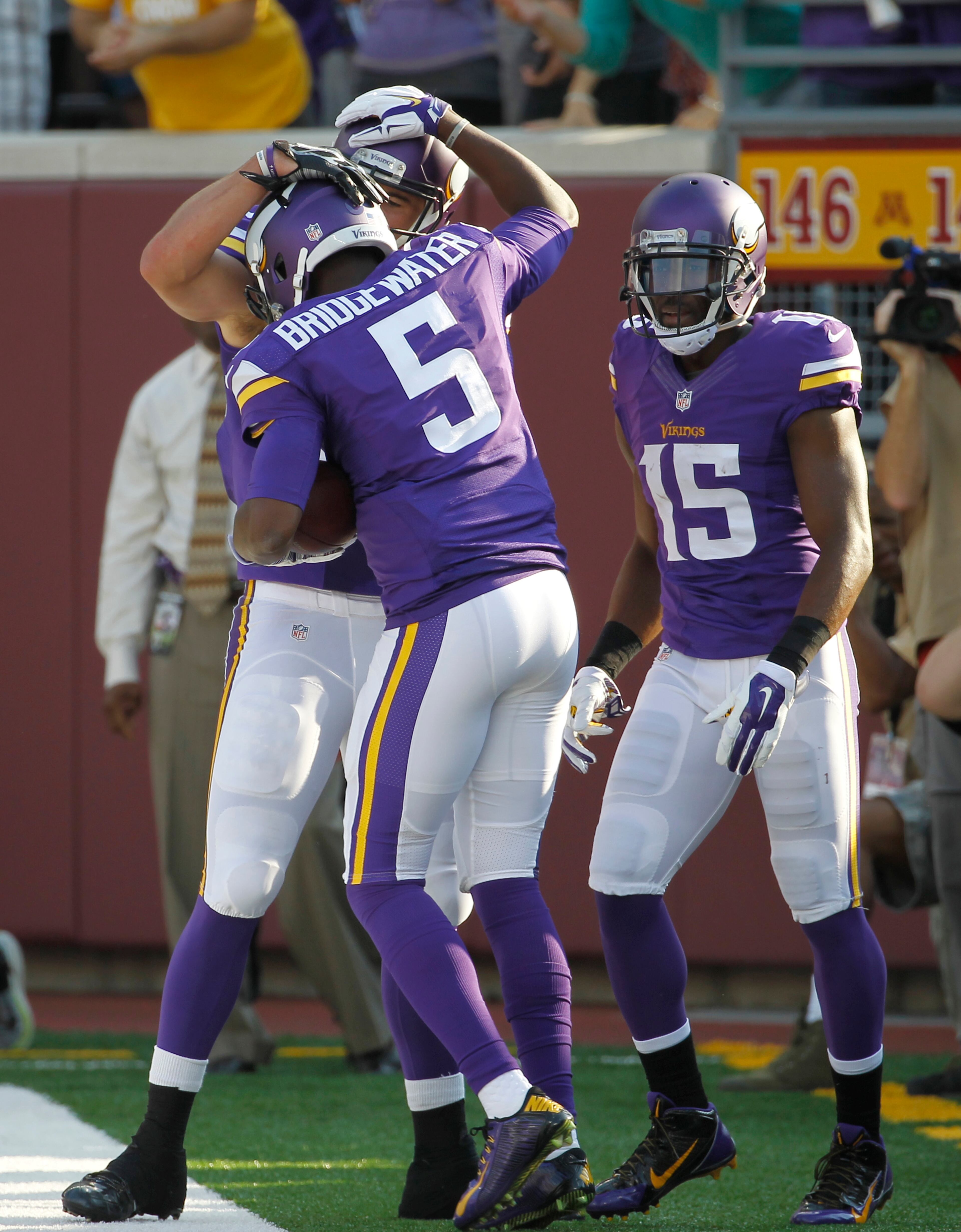 Minnesota Vikings quarterback Teddy Bridgewater (5) celebrates with teammates after a 13-yard touchdown run in the first half of an NFL football game against the Atlanta Falcons , Sunday, Sept. 28, 2014, in Minneapolis. (AP Photo/Ann Heisenfelt)
