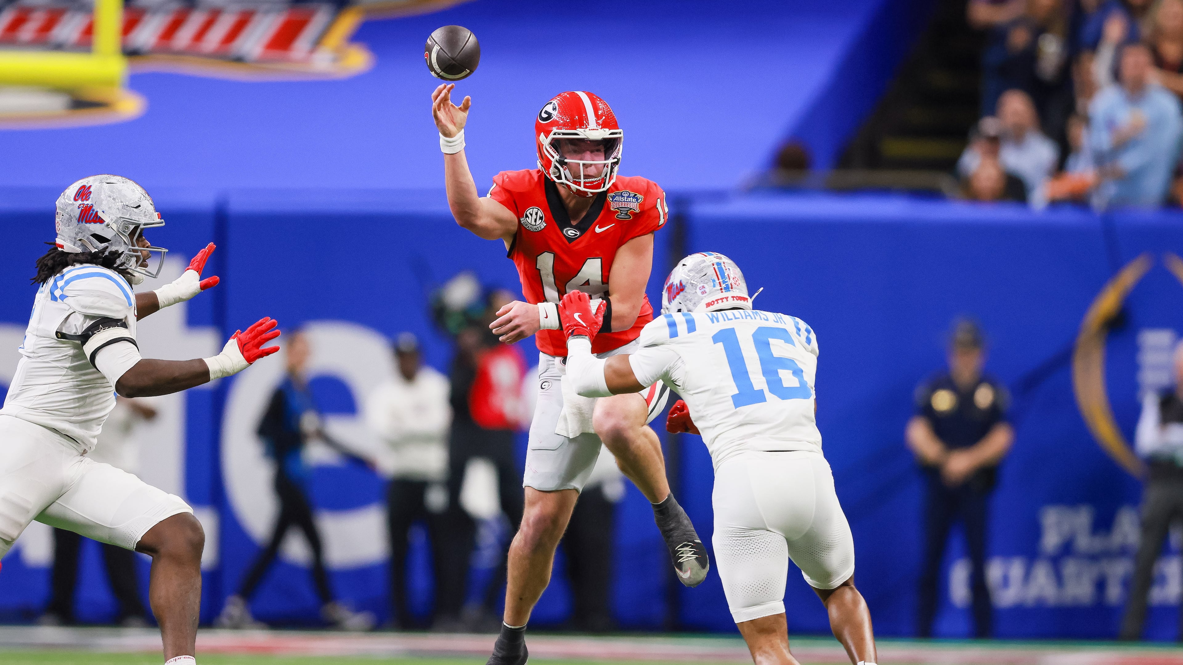 Georgia quarterback Gunner Stockton (center) faces pressure from Ole Miss safety Wydett Williams Jr. (right) during the Sugar Bowl at the Caesars Superdome on Thursday, Jan. 1, 2026, in New Orleans. The Rebels beat the Bulldogs, 39-34. (Jason Getz/AJC)