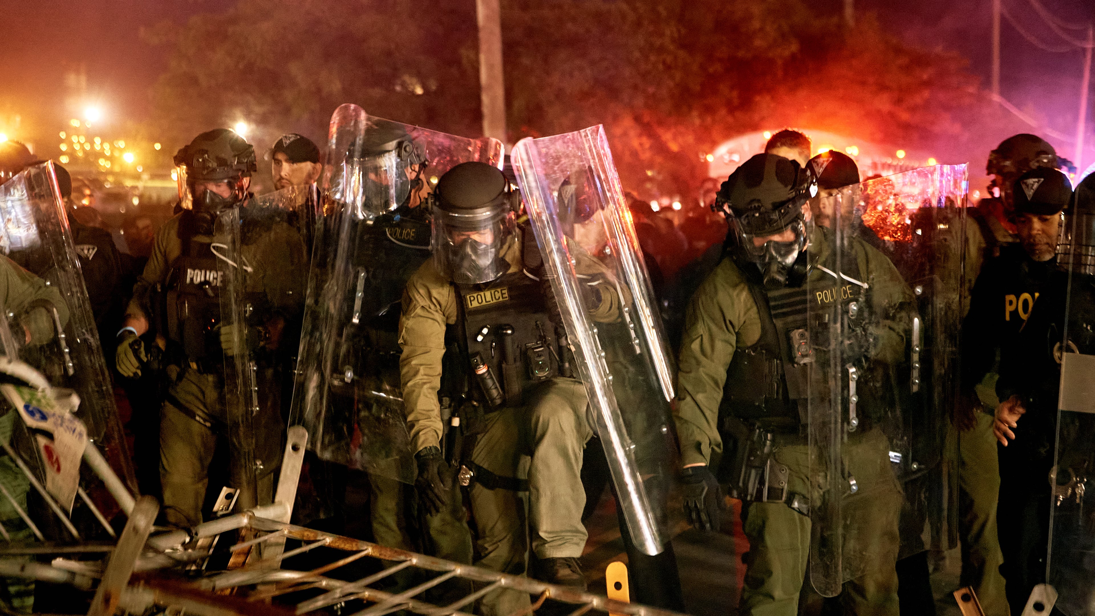 Police pass over a barricade as they clash with protesters near the Delaney Hall detention center during a protest against the transfer of detainees and federal immigration policies on Saturday, May 30, 2026, in Newark, N.J. (AP Photo/Andres Kudacki)