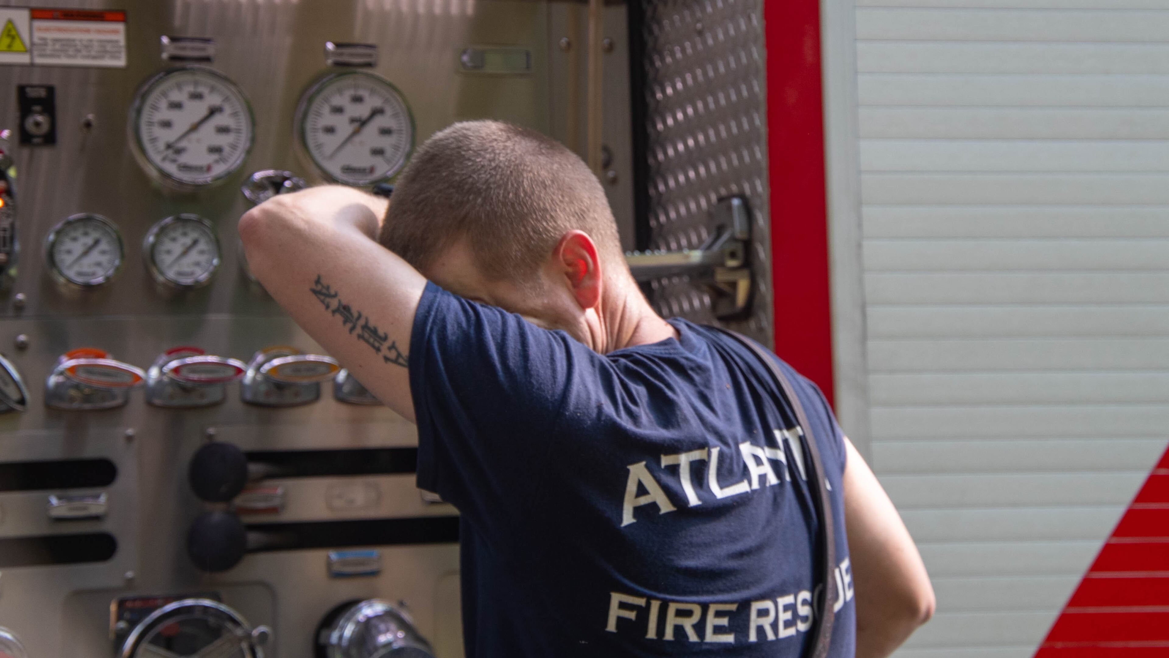 Atlanta Fire Departments Station 16, Lee Laughner wipes the sweat off after working tirelessly in the record breaking heat in Atlanta on Friday, June 30, 2023.