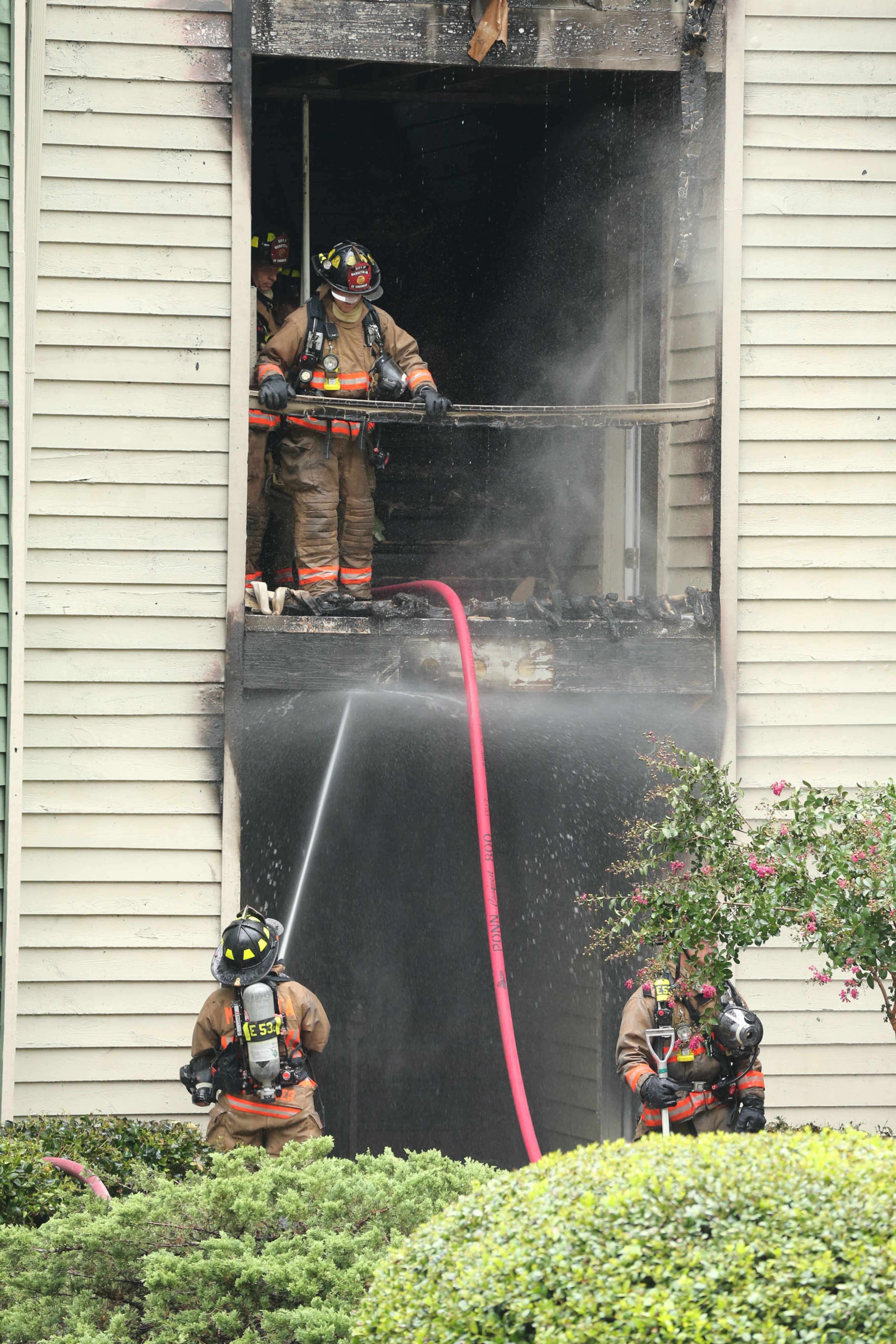 Cobb firefighters respond to a blaze at an apartment building on Powder Springs Road just south of Marietta on Friday, August 16, 2013.