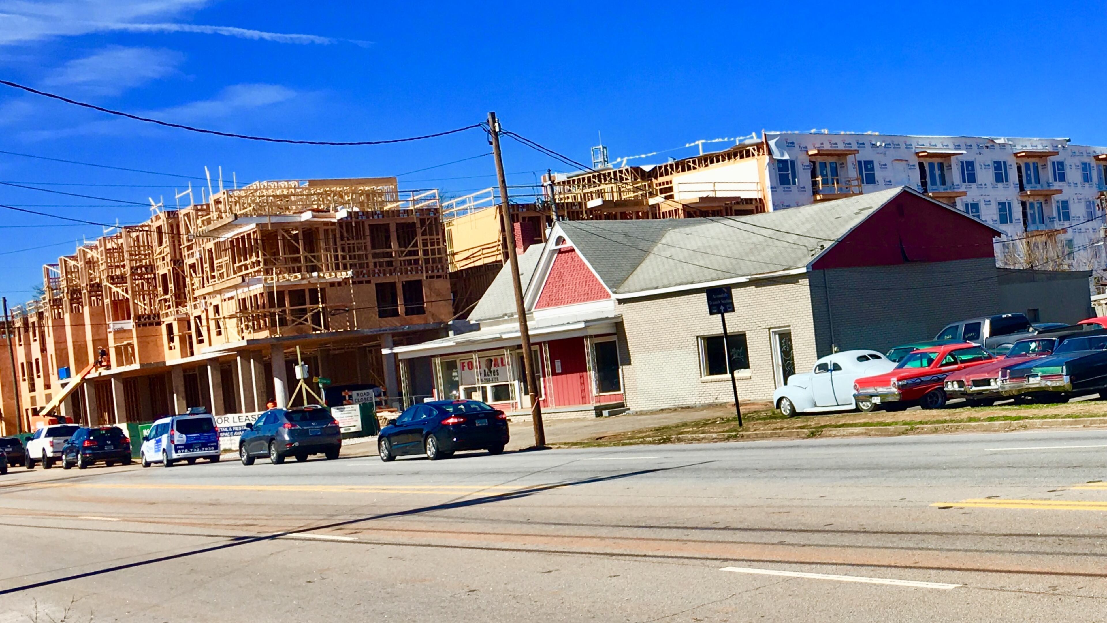 The foreground (with parked cars and abandoned building) is part of the site for a proposed 281-apartment development. Whether that project gets completed, or even started, likely depends on an August 27 Avondale Estates city commission vote. This week the city’s Architectural Review Board and Planning & Zoning Board declined recommending the development. Bill Banks file photo for the AJC