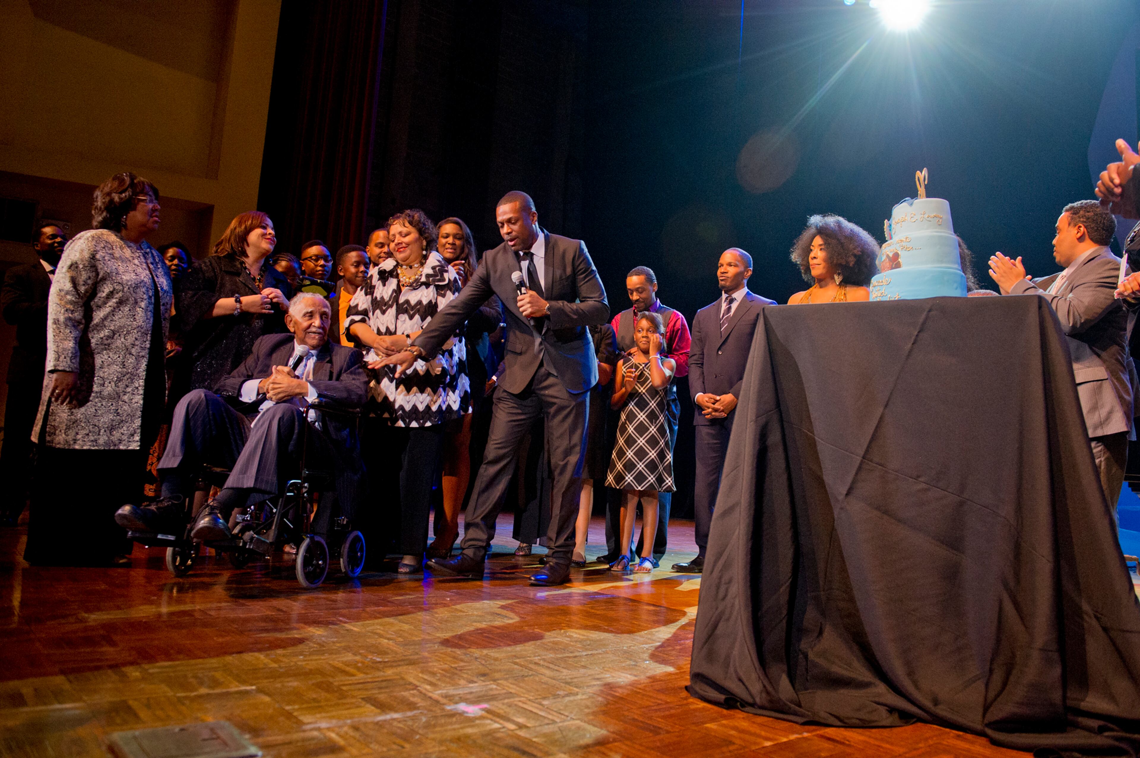 Rev. Dr. Joseph E. Lowery (left seated) is surrounded by friends and family as his birthday cake is wheeled out on stage during I've Known Rivers: A Legendary Life, a tribute to Lowery's 92nd birthday at Morehouse College in Atlanta on Sunday, October 6, 2013. The celebration included appearances by Chris Tucker Malcolm Jamal Warner, Jamie Foxx, Tyler Perry and others. JONATHAN PHILLIPS / SPECIAL