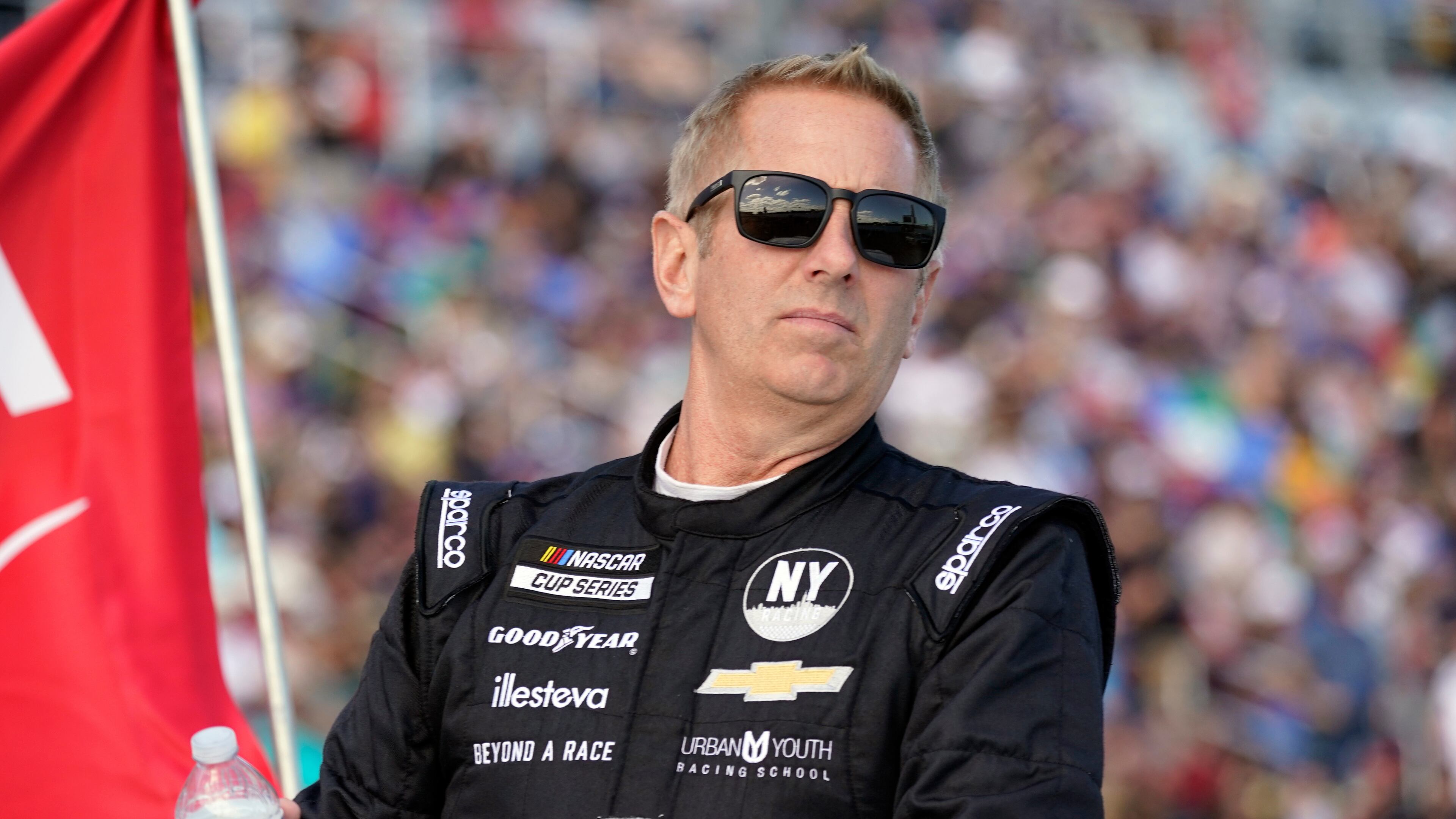 FILE - Greg Biffle looks on during driver introductions before the NASCAR Daytona 500 auto race at Daytona International Speedway, in Daytona Beach, Fla., Feb. 20, 2022. (AP Photo/John Raoux, File)