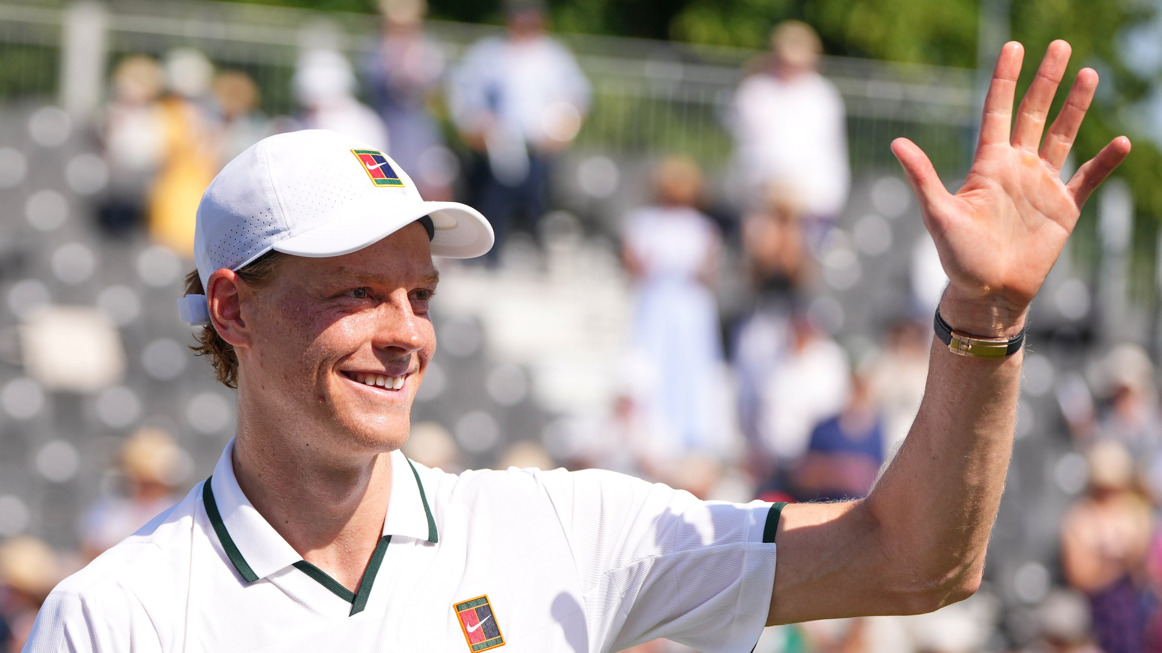 Jannik Sinner of Italy waves to supporters after a tennis exhibition match against Cameron Norrie of Great Britain at the Hurlingham Tennis Club in London, Wednesday, June 24, 2026.(AP Photo/Kirsty Wigglesworth)