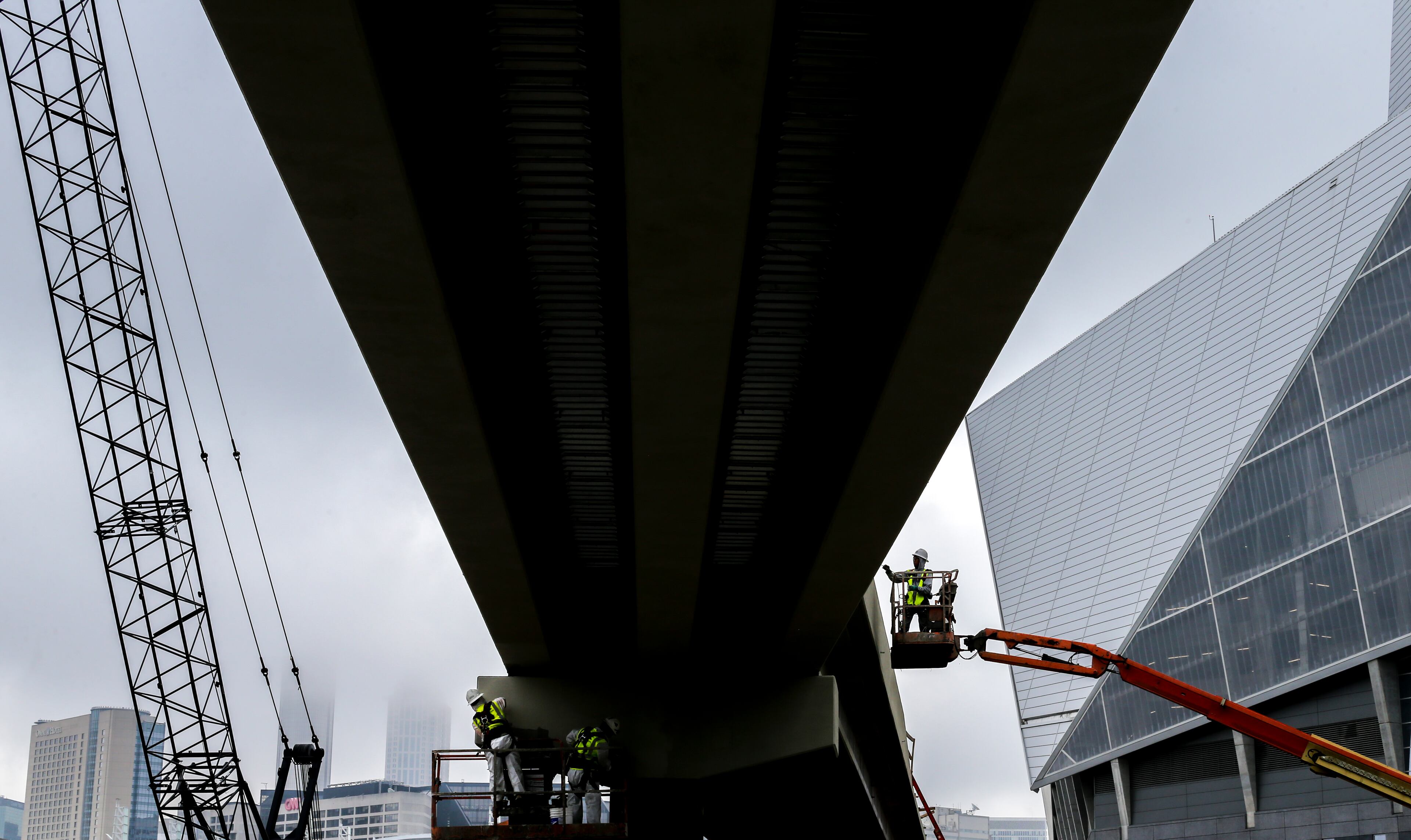 May18, 2018 Atlanta: Workers continued construction under gray skies on Friday morning May 18, 2018 on the Northside Drive Pedestrian Bridge that will connect Mercedes-Benz Stadium and the Vine City MARTA station. Channel 2 Action News meteorologist Karen Minton said Fridays clouds and rain was great news for allergy sufferers. Pollen levels have plunged because of the wet weather. Fridays count was 4 particles per cubic meter of air, which is far short of the season high of 5,354 recorded on April 12. Rain chances are 60 percent for the weekend, Monday and Tuesday. The trend of showers developing in the afternoon and evening should continue through next week, Minton said. Atlanta city officials said the pedestrian bridge project would cost no more than $12.8 million. The Transportation Committee meeting late last February requested that the committee approve an additional $12.3 million in funding because of next years NFL Super Bowl, which will be played at Mercedes-Benz. JOHN SPINK/JSPINK@AJC.COM