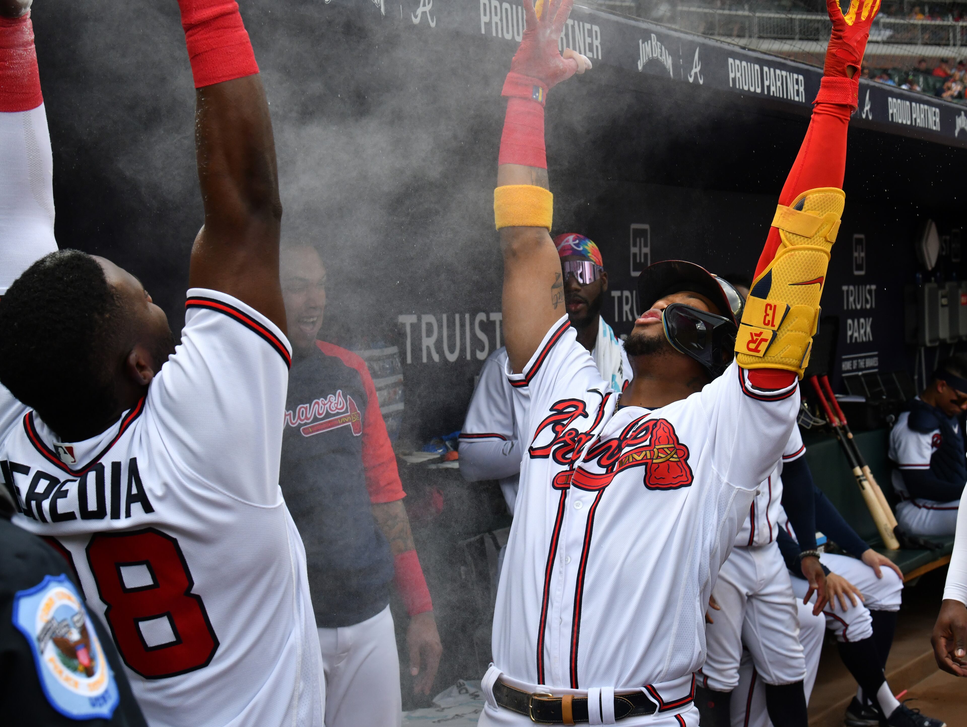 Ronald Acuna celebrates in the dugout with Guillermo Heredia after hitting a solo home run against Pittsburgh Pirates in the first inning at Truist Park on Saturday, June 11, 2022. (Hyosub Shin / Hyosub.Shin@ajc.com)