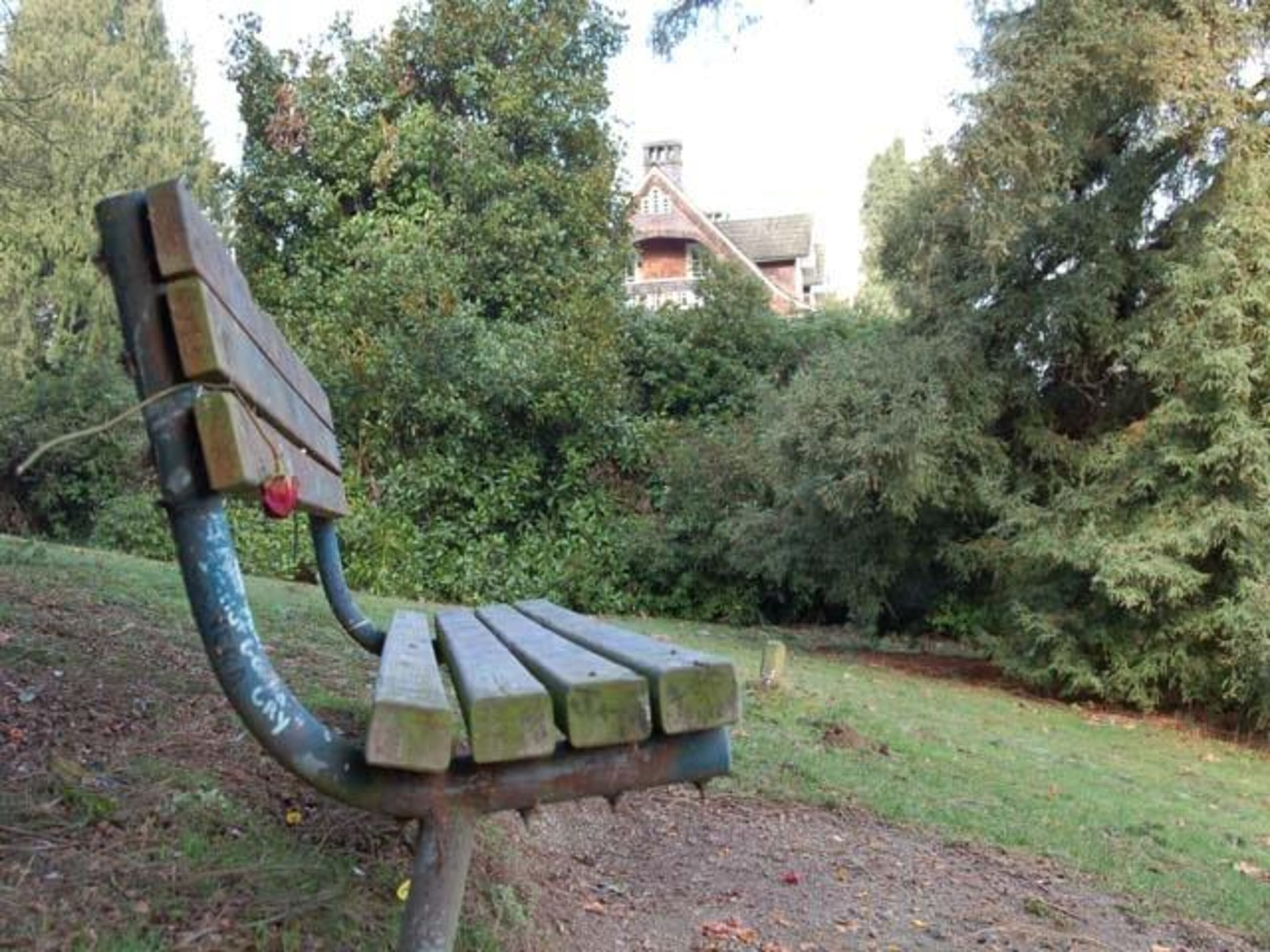 A memorial bench at "Kurt's Park" with the home pictured in the background.
