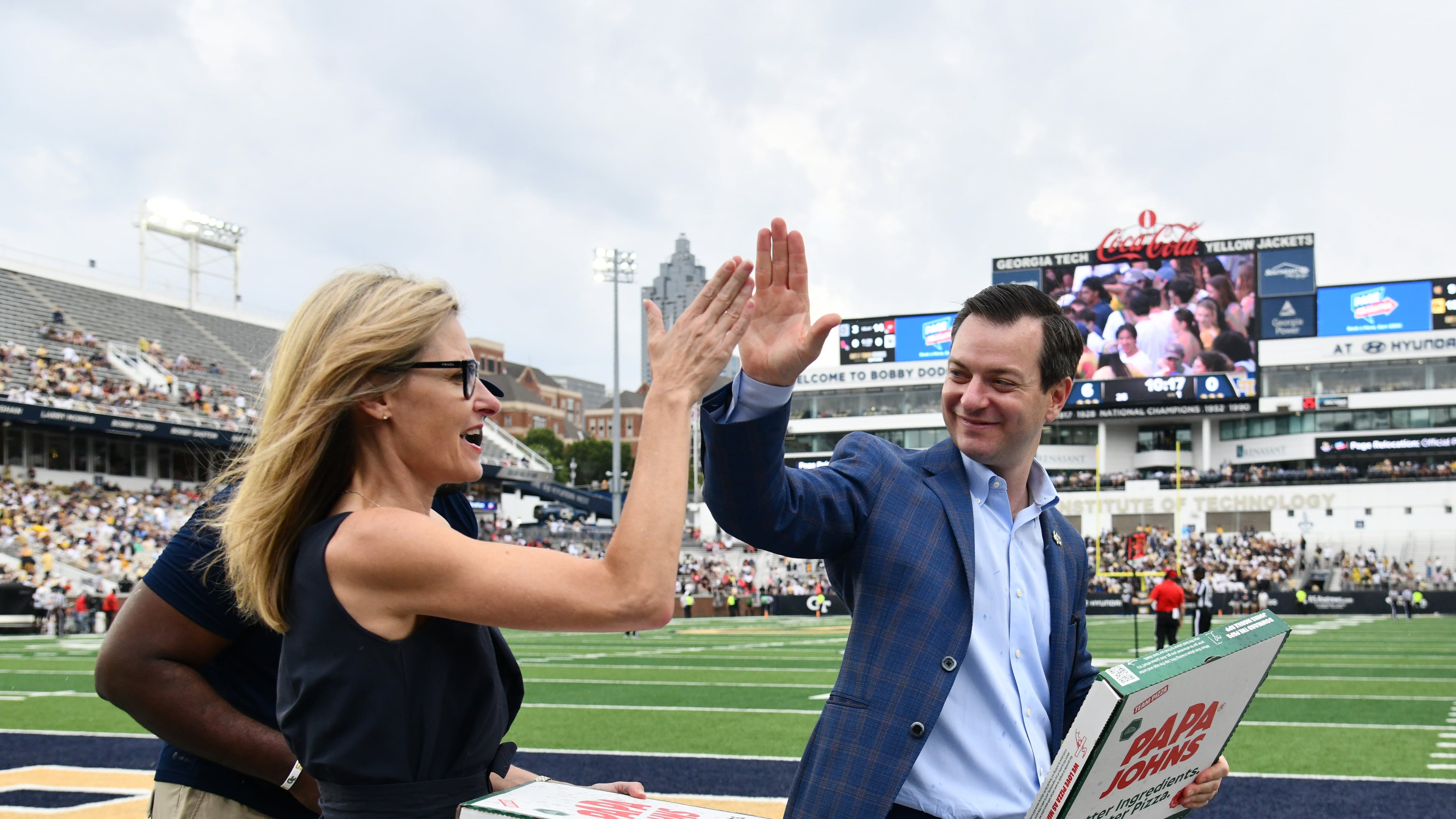 Ryan Alpert, director of athletics, high-fives Karie Davis-Nozemack, interim provost and executive vice president for academic affairs, during an NCAA college football game at Georgia Tech's Bobby Dodd Stadium, Saturday, September 6, 2025, in Atlanta. Georgia Tech won 59-12 over Gardner-Webb. (Hyosub Shin AJC)